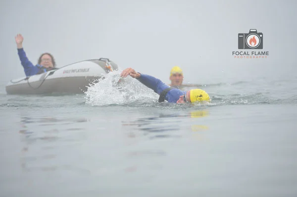 The swim is a team effort, with Care2Tri members taking turns pulling an inflatable vessel carrying another member. © 2014 Focal Flame Photography | Photo credit: Austin Cope