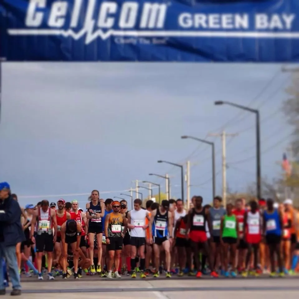 Emily Kurian (left-center, jumping) at the Green Bay Marathon. Credit: David Mari