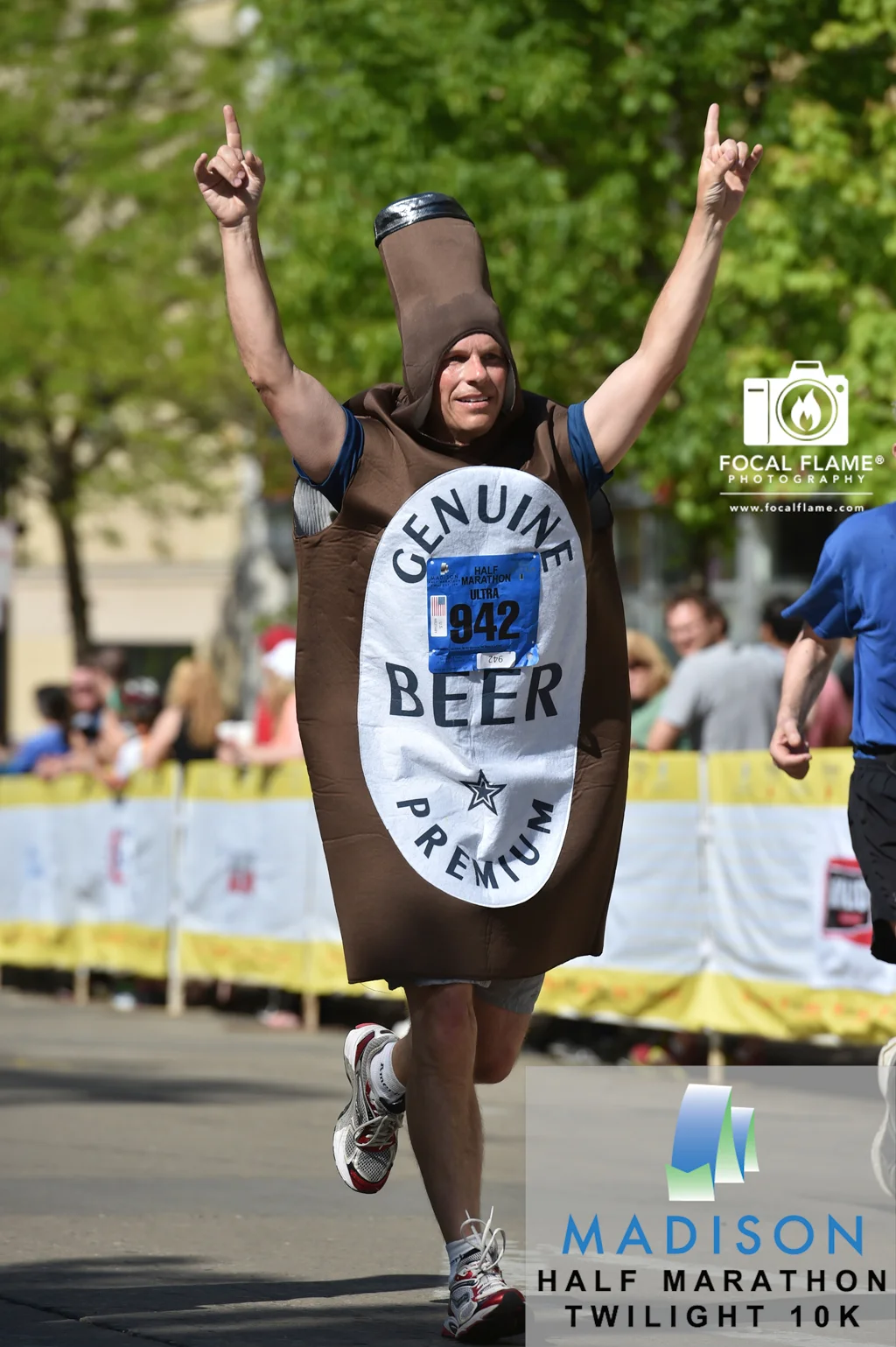 Brent Kimbel gives a victory salute during the 2014 Spring Madison Half Marathon. © 2014 Focal Flame Photography | Photo credit: Clint Thayer
