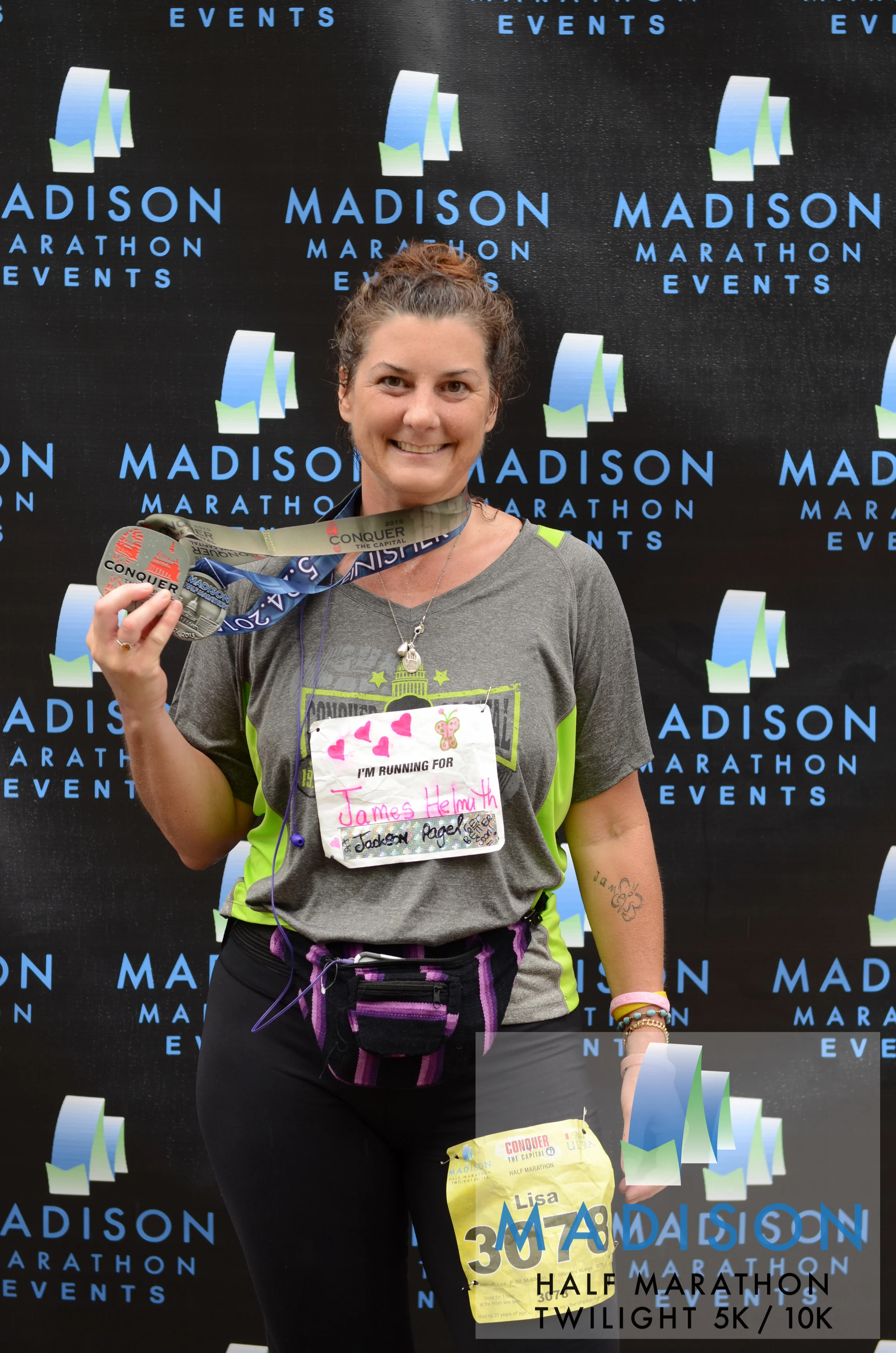 Lisa celebrates finishing the spring 2015 Madison Half Marathon. She also ran the Twilight 10K the evening beforehand, a combination called "Conquer the Capitol." © 2015 Focal Flame Photography | Photo credit: Shannon Lund