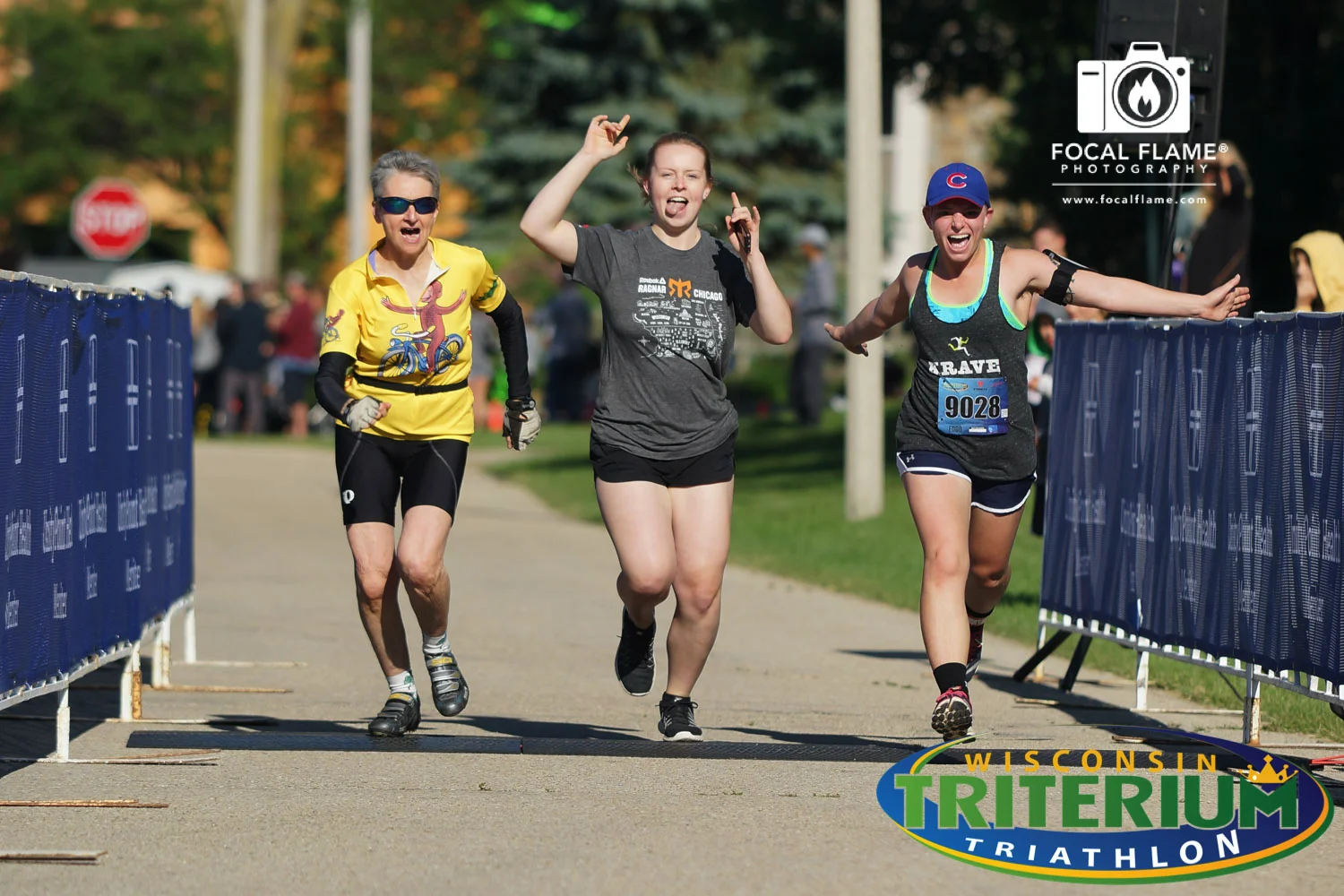 Members of a first-place triathlon relay team make it clear they are together, allowing a great group shot at the finish line. (c) 2017 Focal Flame Photography | Photo credit: Josh Zytkiewicz