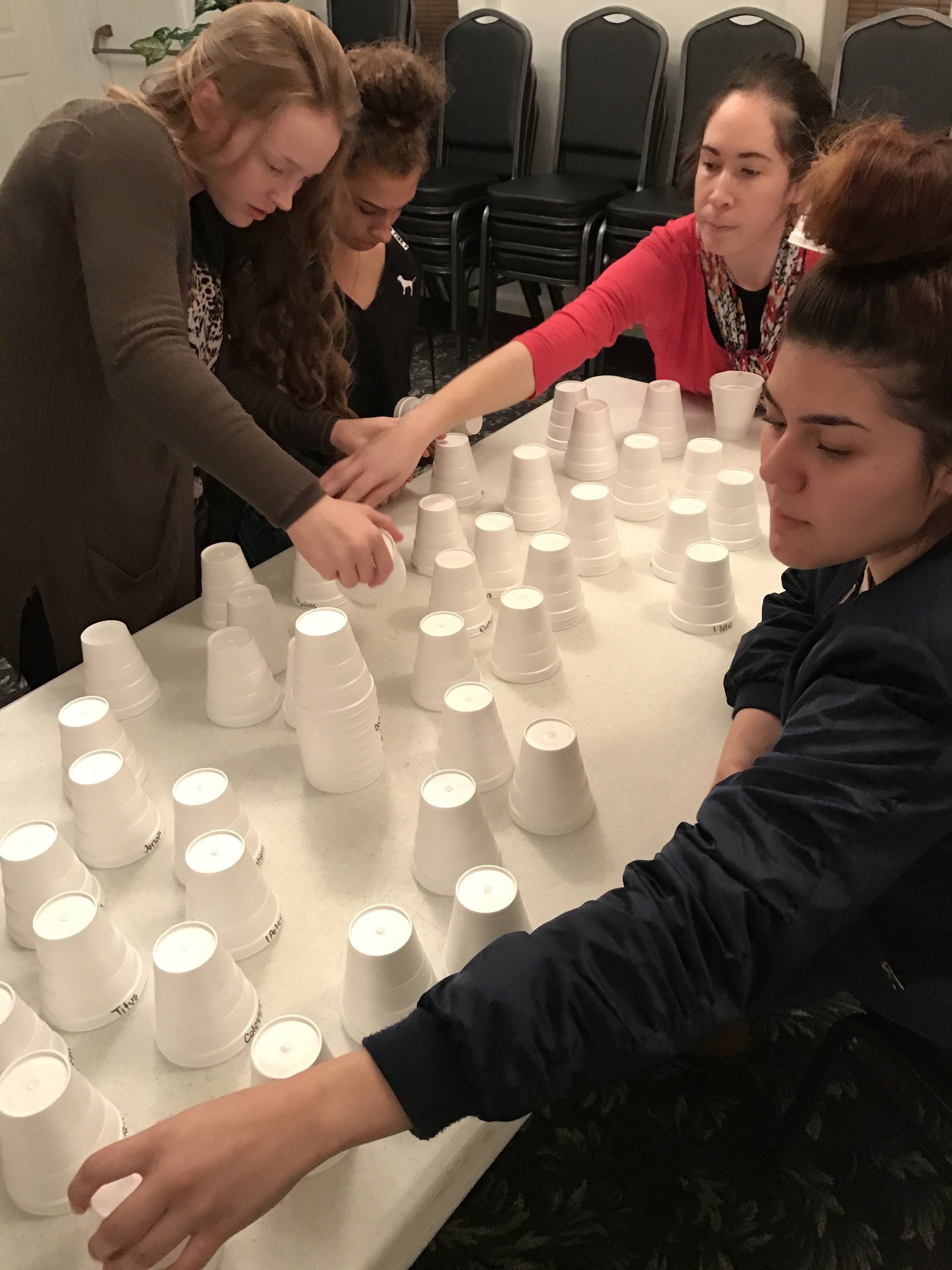 Girls working on getting the books of the Bible in order.