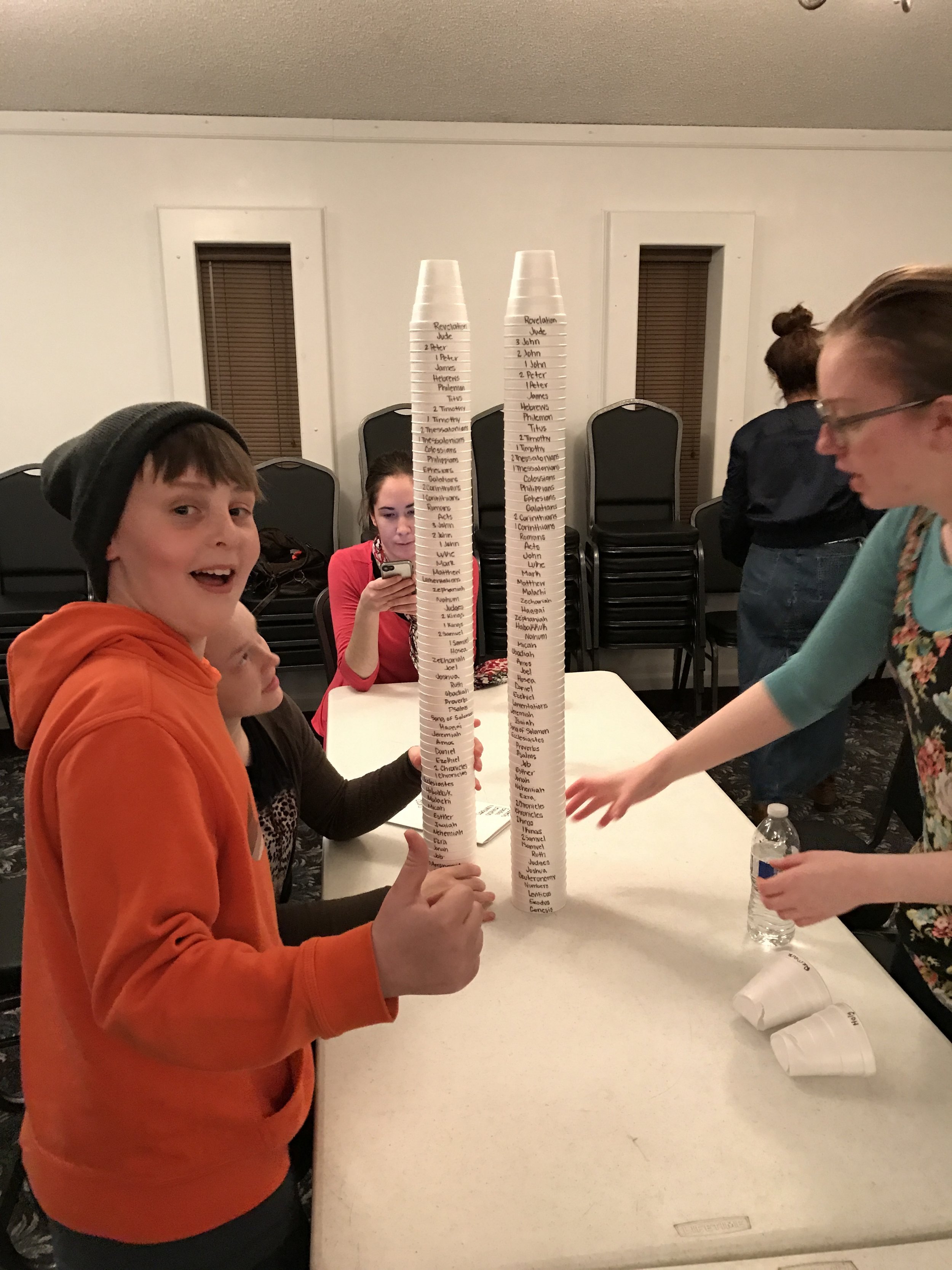 Whoa! That is one tall stack. Sis. Sarah checking to make sure they are all in order correctly.