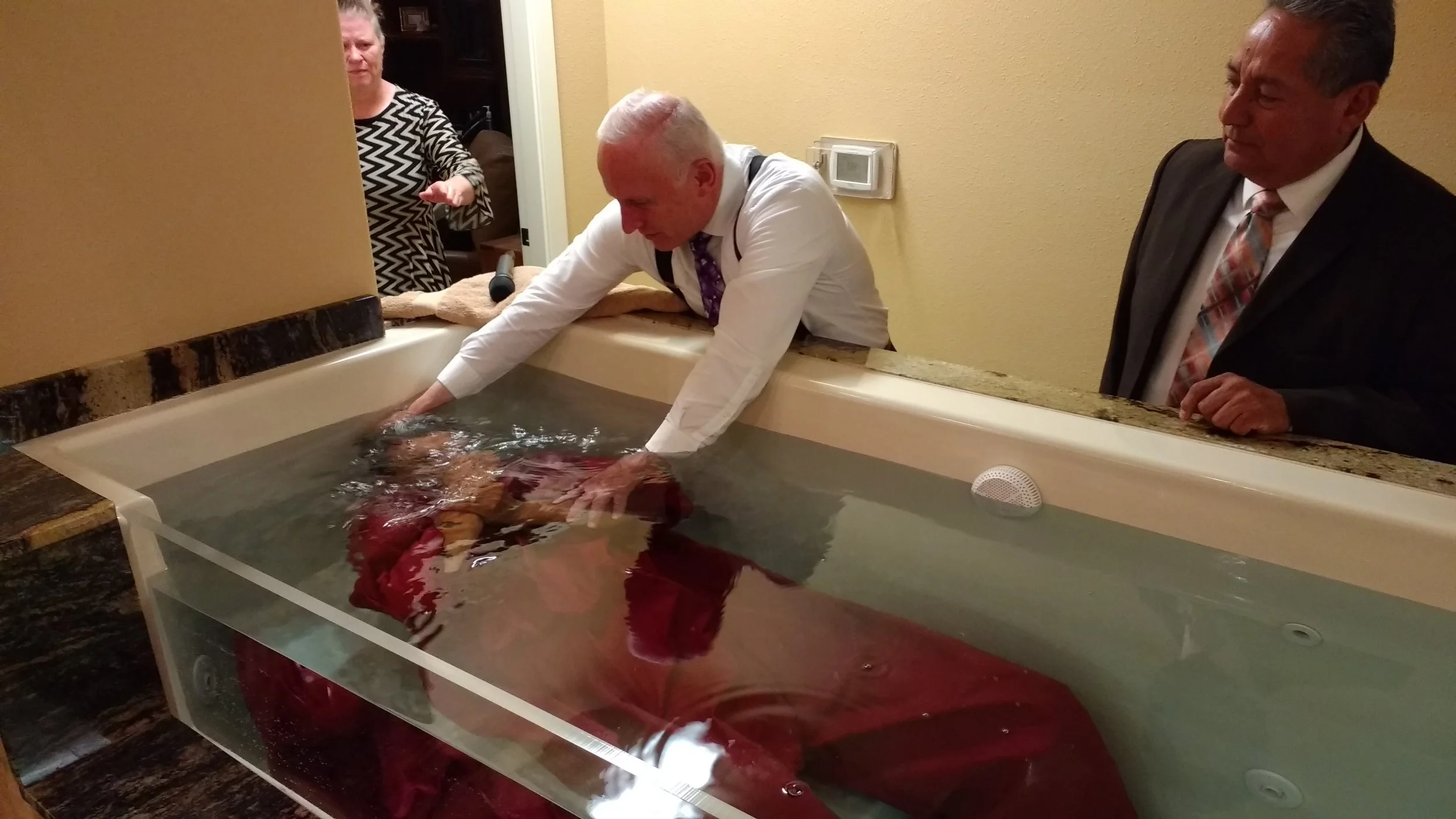 Andrew going down into the water in Jesus Name