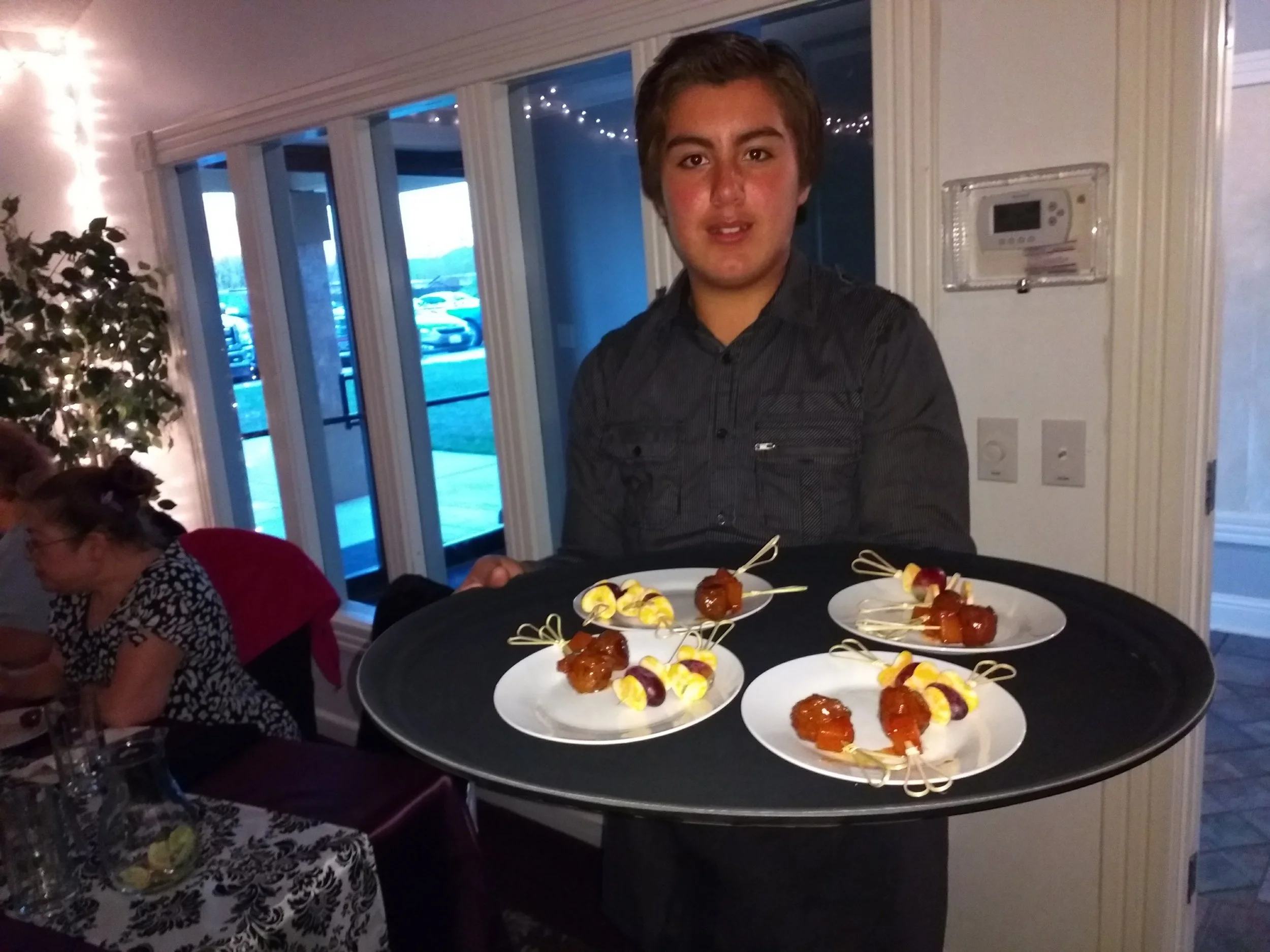 Ninos serving appetizers