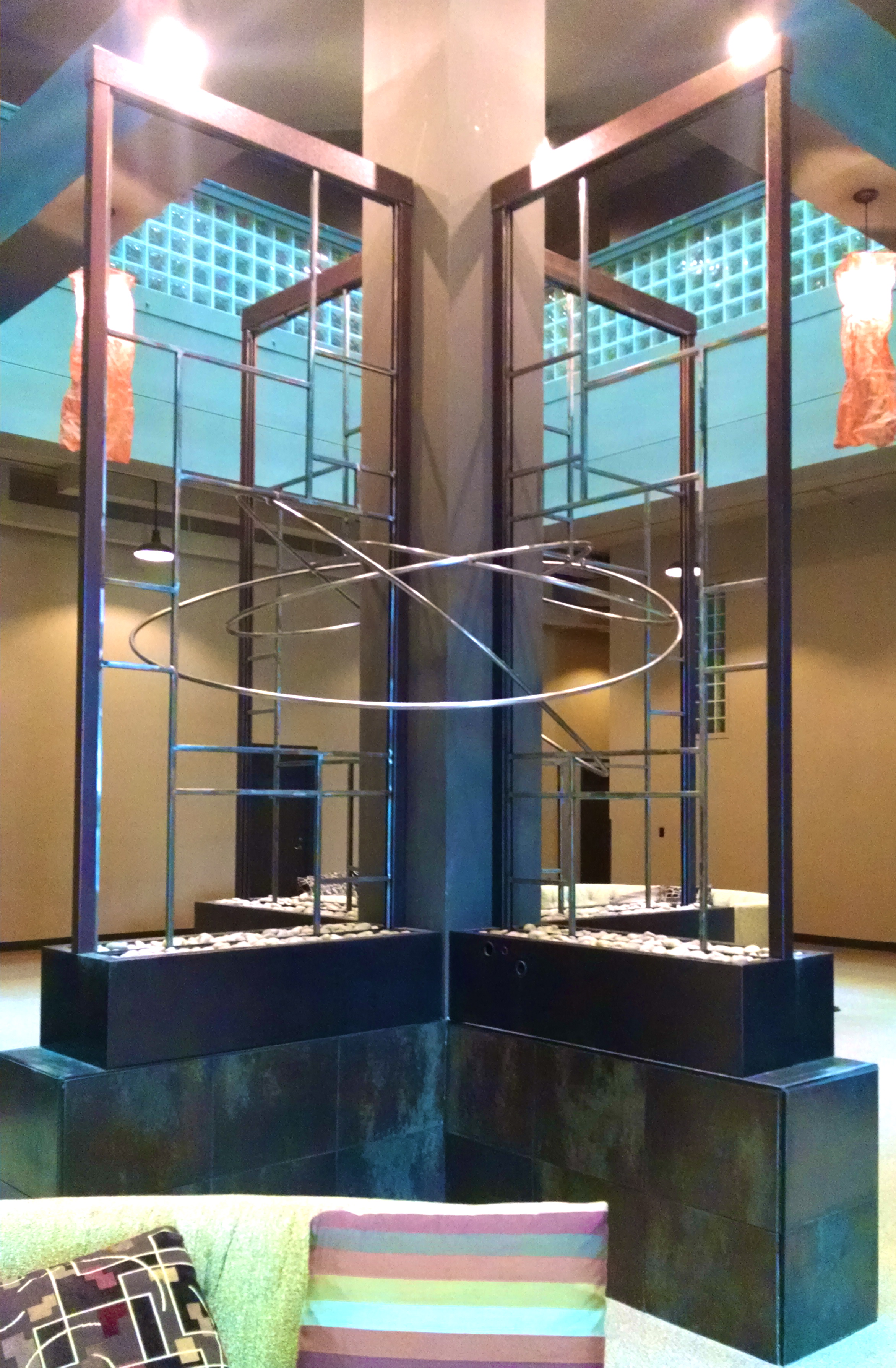Bottleworks Loft Condominiums, Cedar Rapids, IA. Their atrium water feature became too problematic to maintain, so we removed the glass, and I redesigned/rebuilt the frames to suit the space while being maintenance-free.