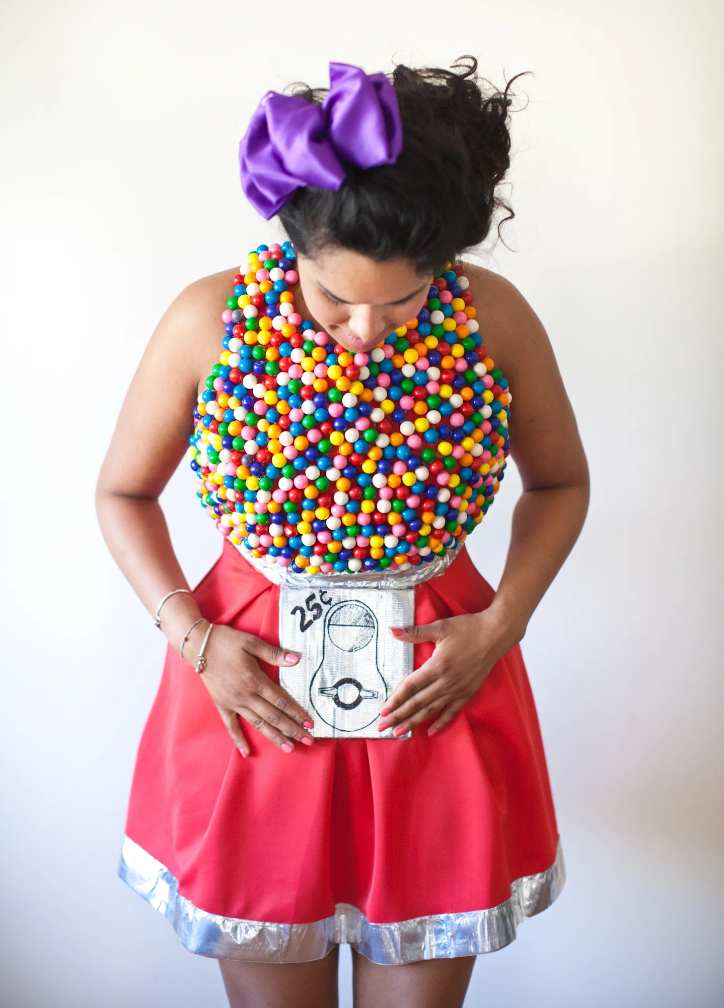 Thanks to my lovely sister here's a tutorial on how to make your very own gumball machine costume! - Duck Tape - 1 black sharpie pen - 2 to 3 bags of machine size gumballs -5.5 x 6.5 inch cardboard piece - Red Dress - Hot glue gun