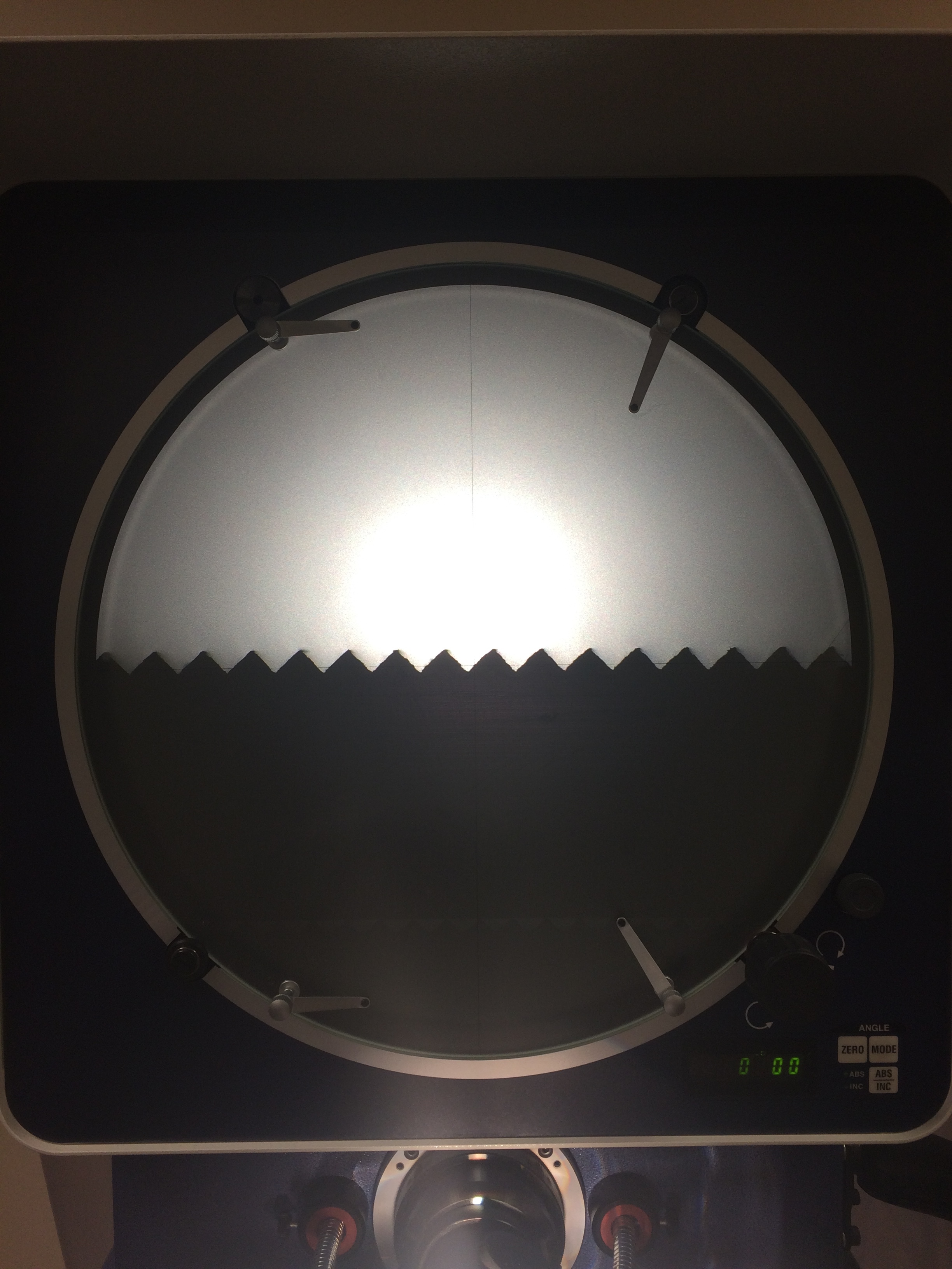  These are the teeth of one of the microbend gratings seen on a comparator. The comparator was used to verify the tooth profile and pitch of the teeth. 