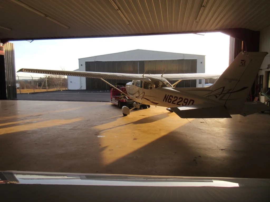 Putting the plane in the hangar (NOT a hanger) overnight. I like the lighting in this shot