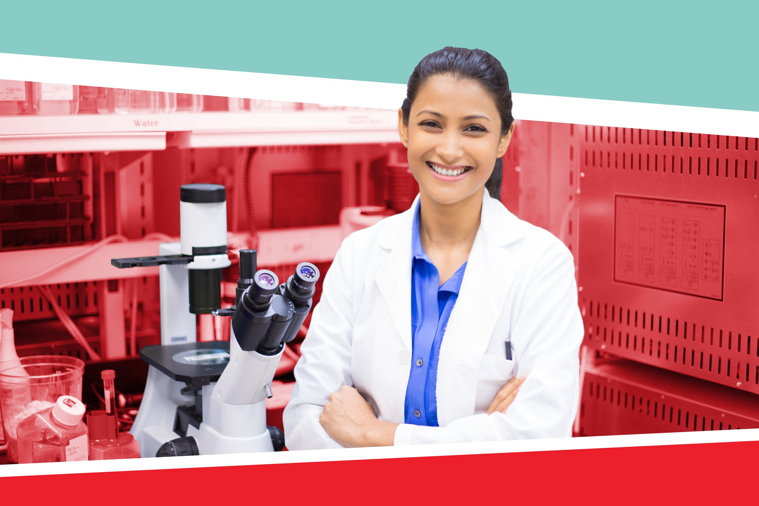 An MD-PhD student smiling and standing in front of a microscope