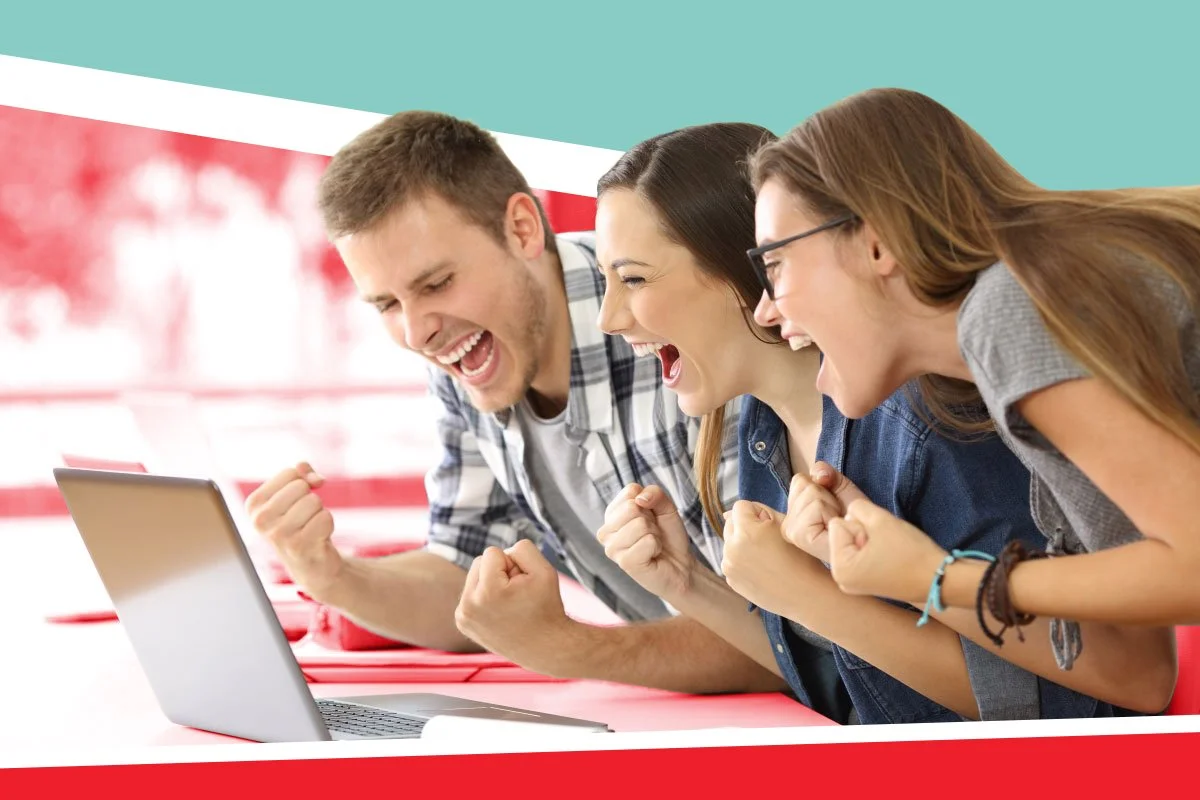3 cheering students looking at laptop after getting good mcat scores