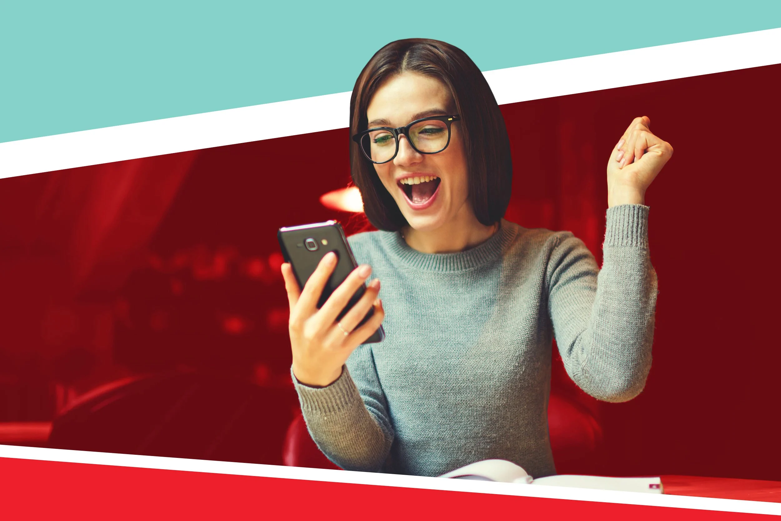 brown-haired woman wearing gray sweater and glasses cheering good mcat score while looking at her phone