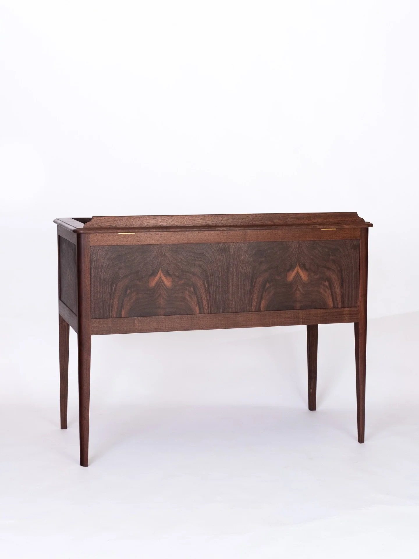 Custom DJ console! 🎶

Two worlds collide with a piece designed to fit in with antique furniture yet house a modern DJ setup. Western walnut with custom veneered panels.