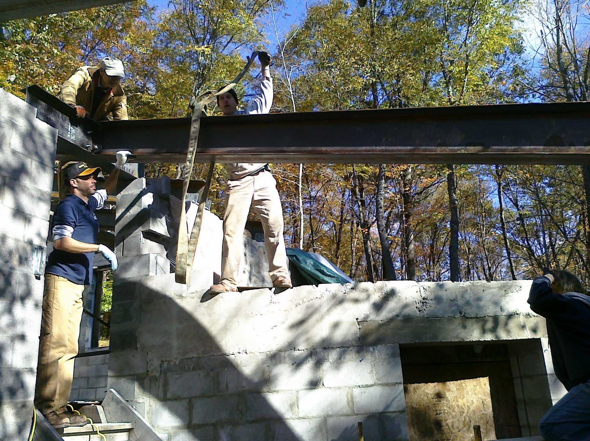 Patrick Toon, Pete Fisher, & Jim Reilly attach a roof beam to the stairway lintel.