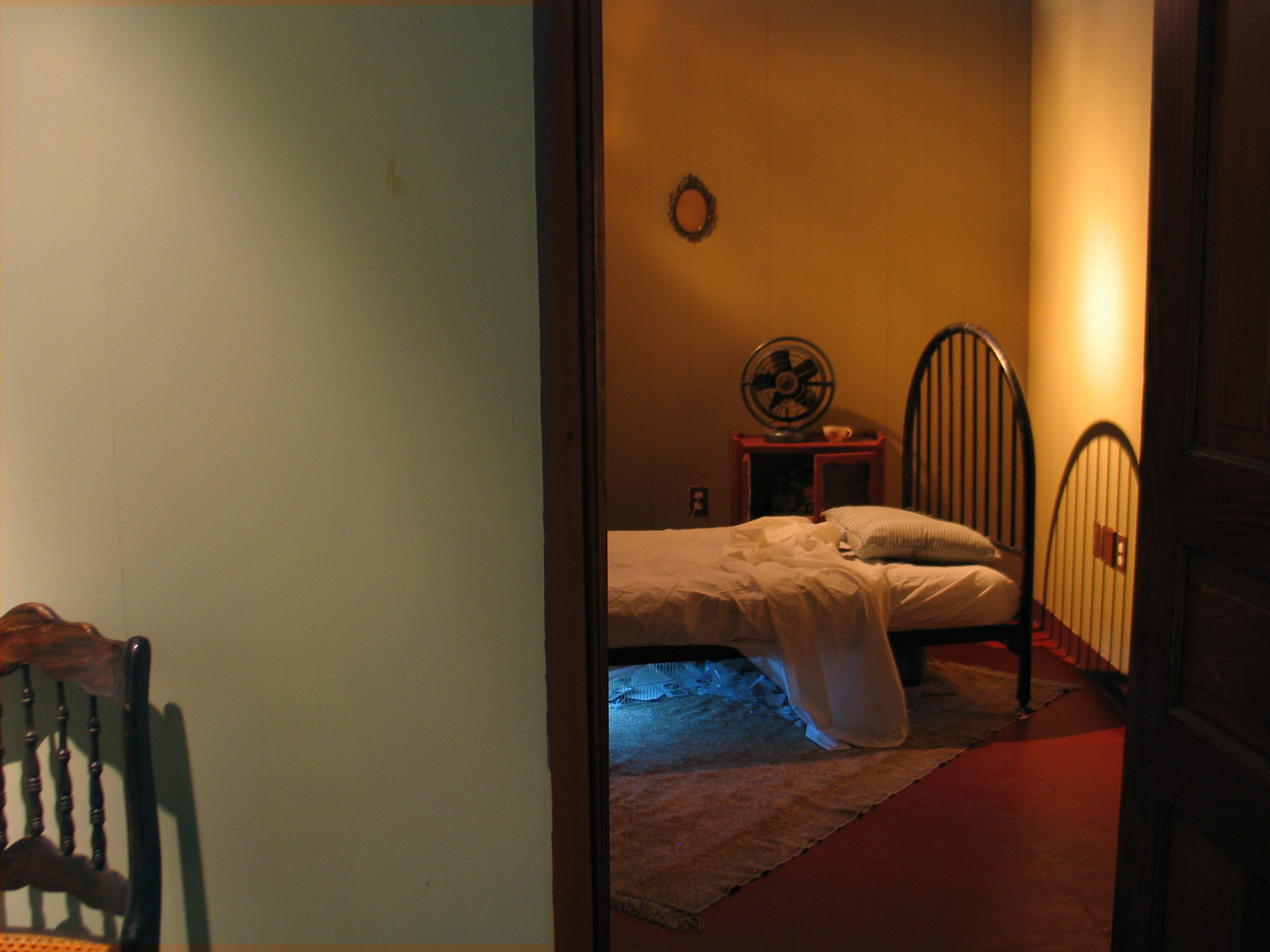 Beneath the Bed. Installation. Dry wall, vinyl wall paper, furniture, objects, television, light. 2009, 2010, and 2012. 