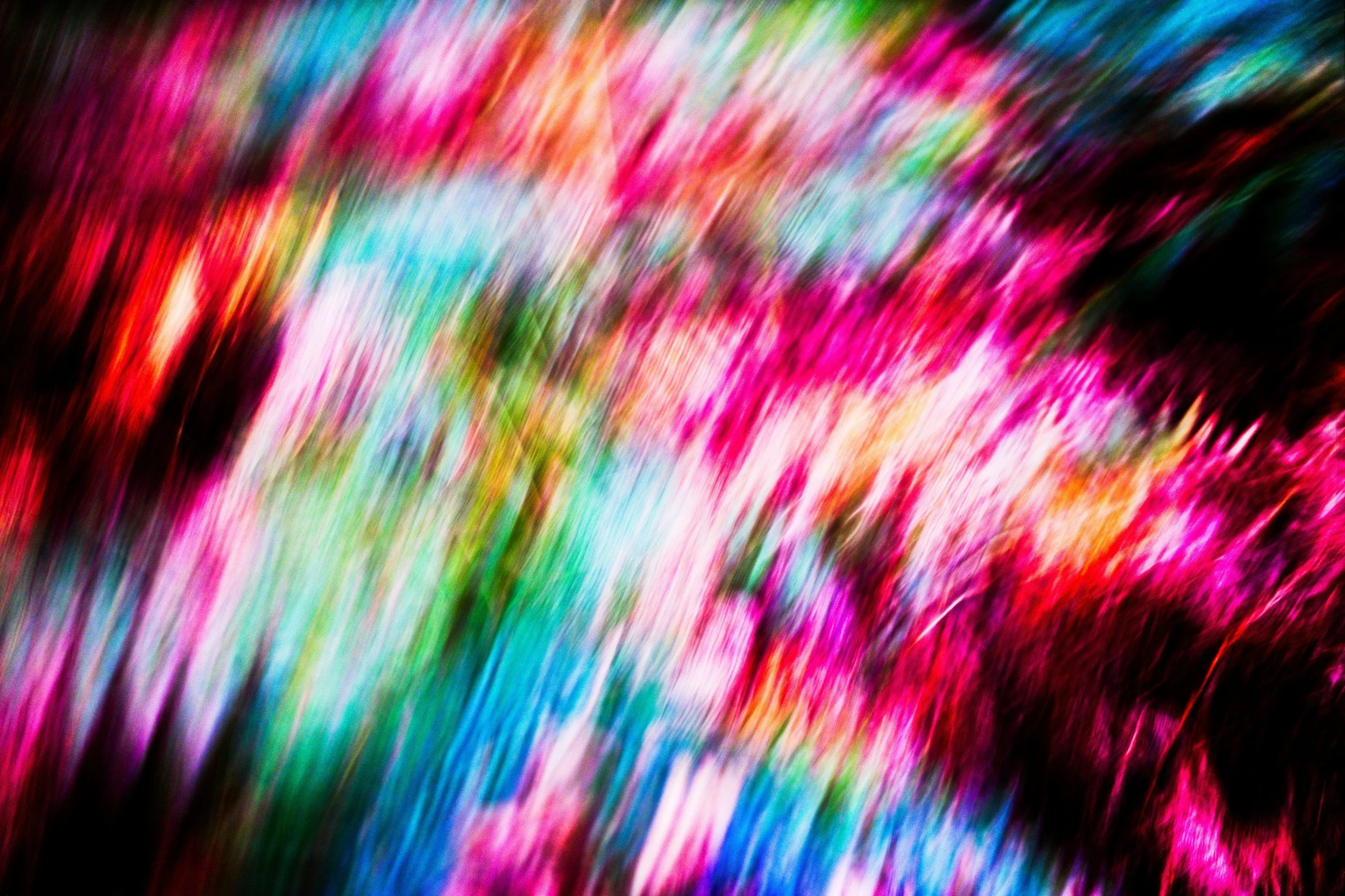 image of blurred pink, red, green, and blue lights