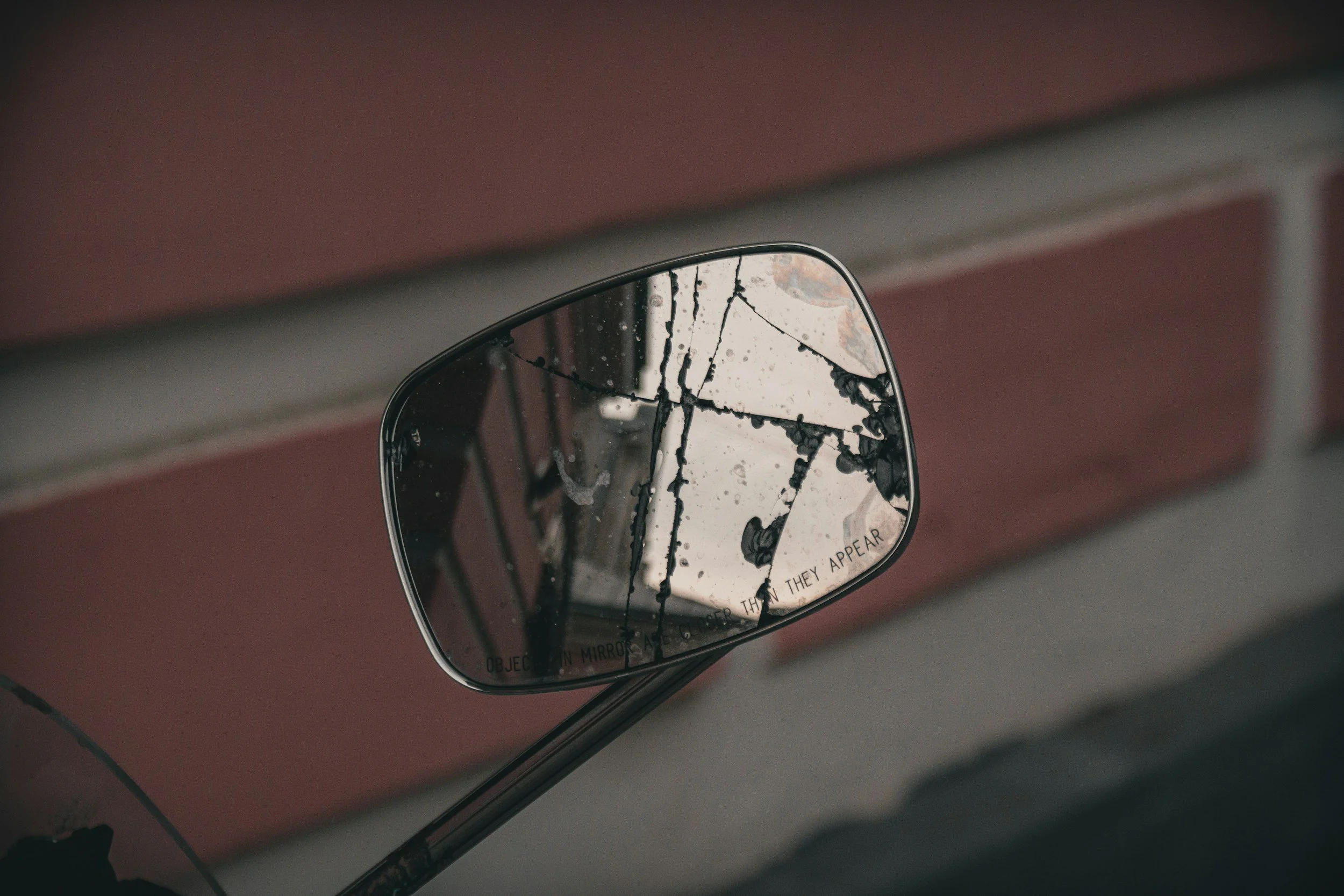 broken rearview mirror depicting the thought that I'm not just a mirror reflecting back my clients