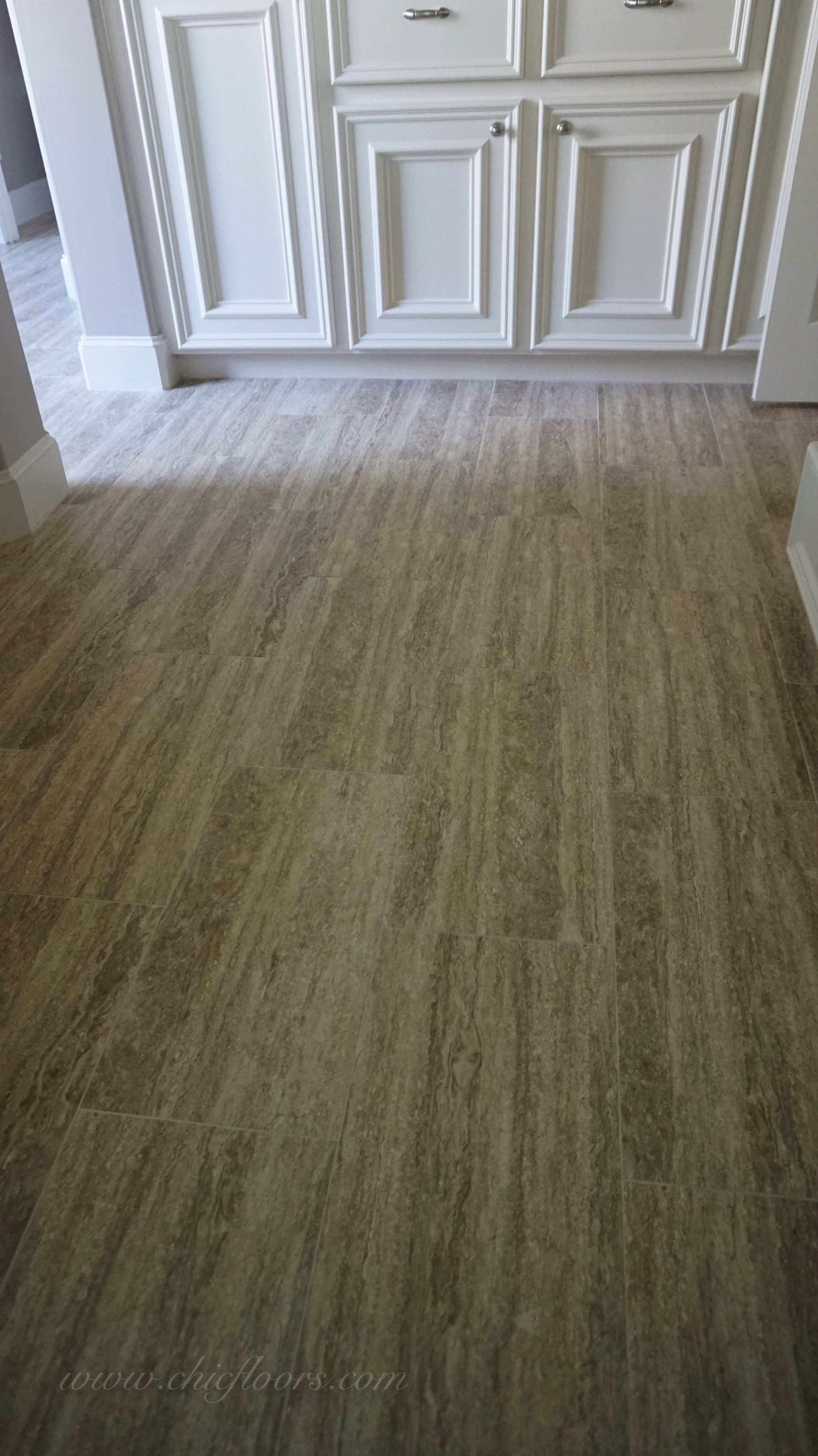 The tile has a linear pattern of cream, brown and gray.