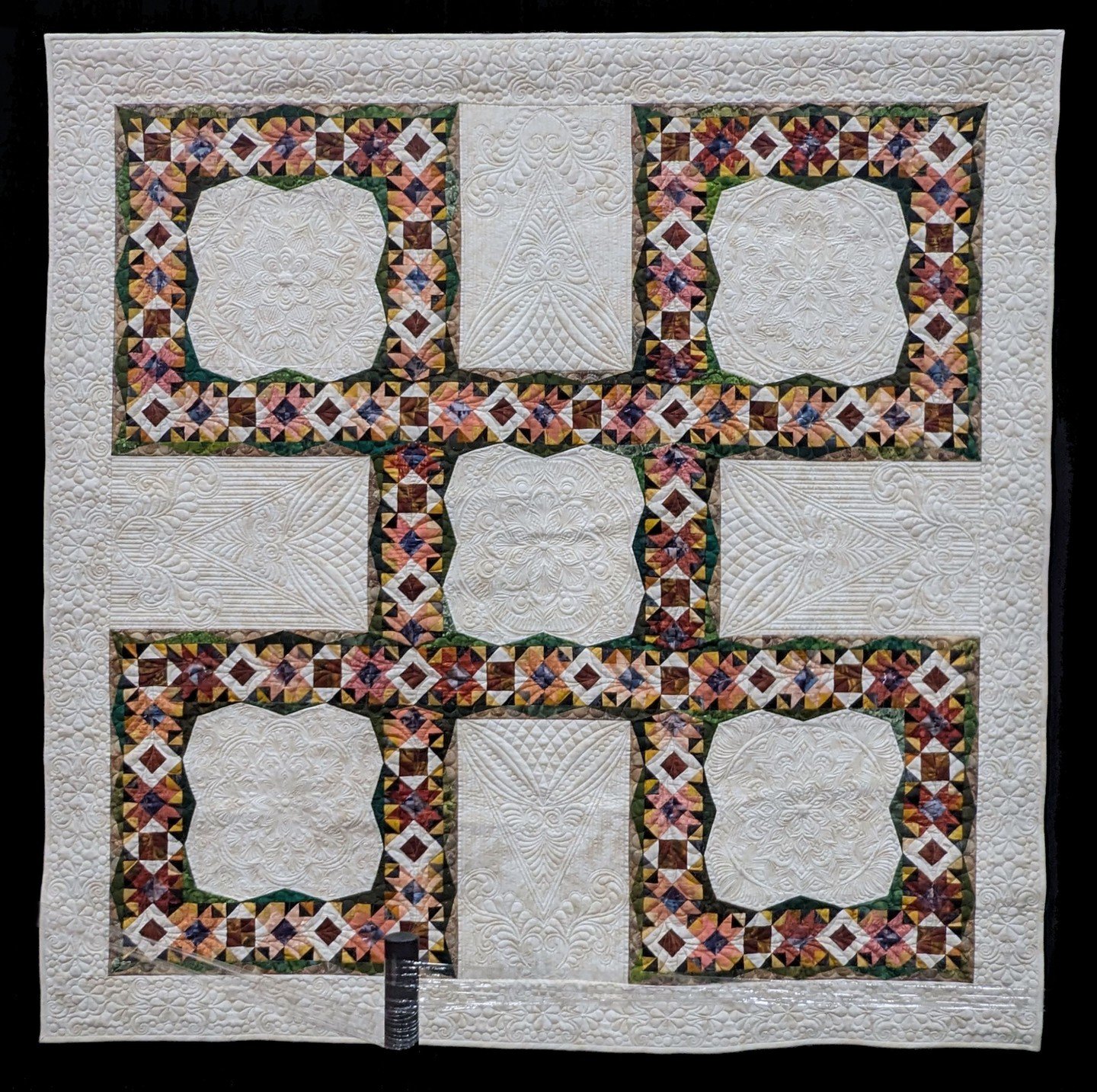 NOT MY WORK. This is For All the Marbles by Darla Orndorff and quilted by Penny Boese. I like the colors used in this quilt, but what really drew me in was the quilting. I'm hoping to up my game in the machine quilting department, but I think in orde