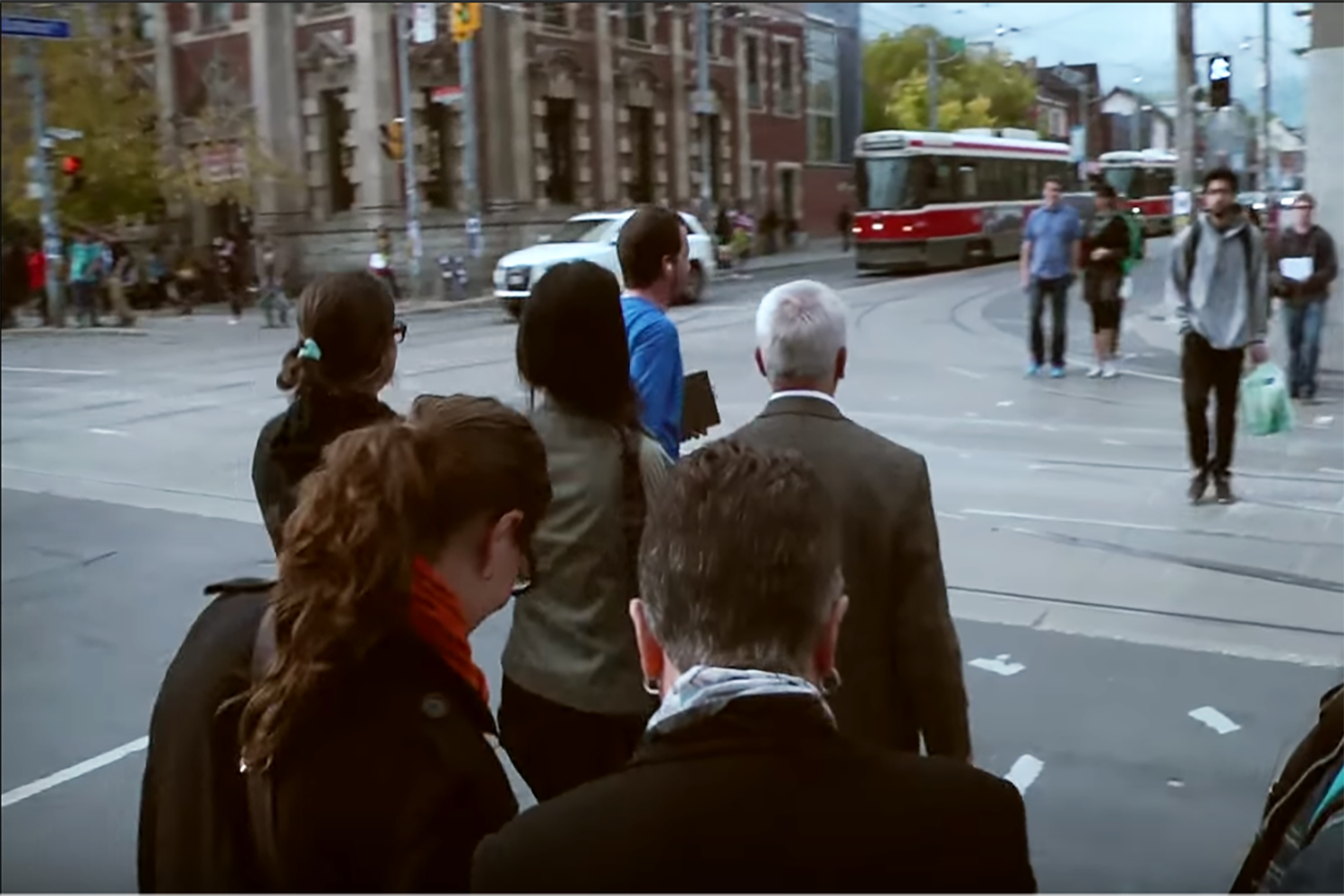 Four Corners Tour Guide and Audience Venturing into Queen and Bathurst.PNG
