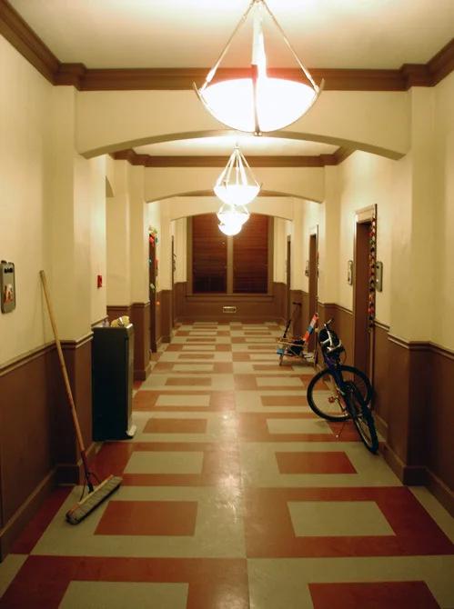 Girls boarding school dormitory hallway stage set.