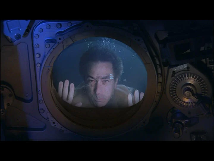 The preacher/former astronaut (David Strathairn) dreams he finds his younger self trapped in his capsule deep beneath the water. Here we draped an indoor diving pool in black, then built a water resistant capsule wall for the gag.