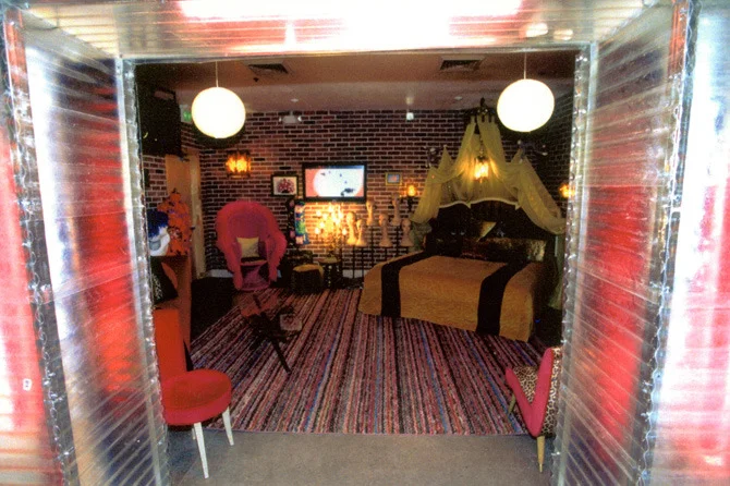 We hid the crummy plastic Chinese restaurant columns and arch inside a translucent corrugated fiberglass and steel portal with red neon inside, since one of the clients requests was a sort of a whorehouse lounge in which press interviews could be held.