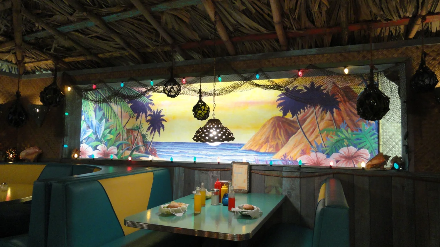 A detail shot of the booths and tropical murals in Big Momma's interior.