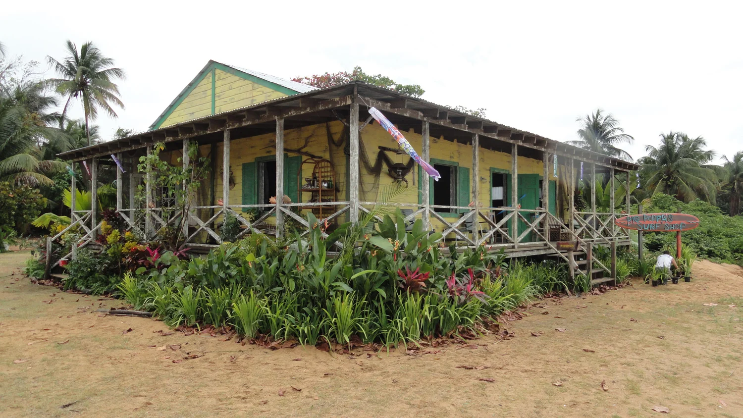 The beginning and end scenes in Teen Beach Movie take place on the same beach as the 1962 period scenes, but in modern times. This is Big Poppa's (Barry Bostwick) surf shop, a home and workshop he shares with his grandaughter McKenzie (Maia Mitchell). After the 1962 portion of the shooting schedule was complete, we had just six days to tear down Big Momma's exterior, and build this interior/exterior house, complete with dressing and greens before the company returned to complete shooting.