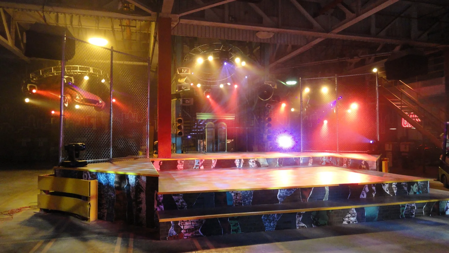 Even more of the story takes place in a teen hip hop club called Off the Street. Thematically we chose to play on that name and create a huge, de-constructed "street" as a safe space for a young crowd to meet, dance, and compete. The set was built in an enormous, abandoned auto manufaturing plant, which gave us the opportunity to incorporate some of it's amazing industrial goodness. This is the main rap-battle stage and DJ booth.