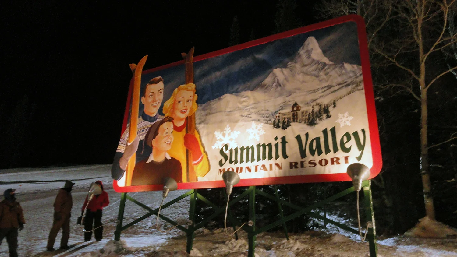 The "historic" Summit Valley billboard. An escaped sled hurtles down the slope and crashes through the prized relic of the resort owner. Here it is rigged with det-cord, ready for a hole to be blown in it before it falls over and crashes on the snow.