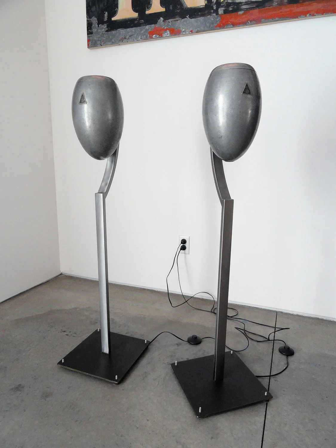 Floor lamps, made from salvaged 1920's automotive head light housings and custom steel bases.