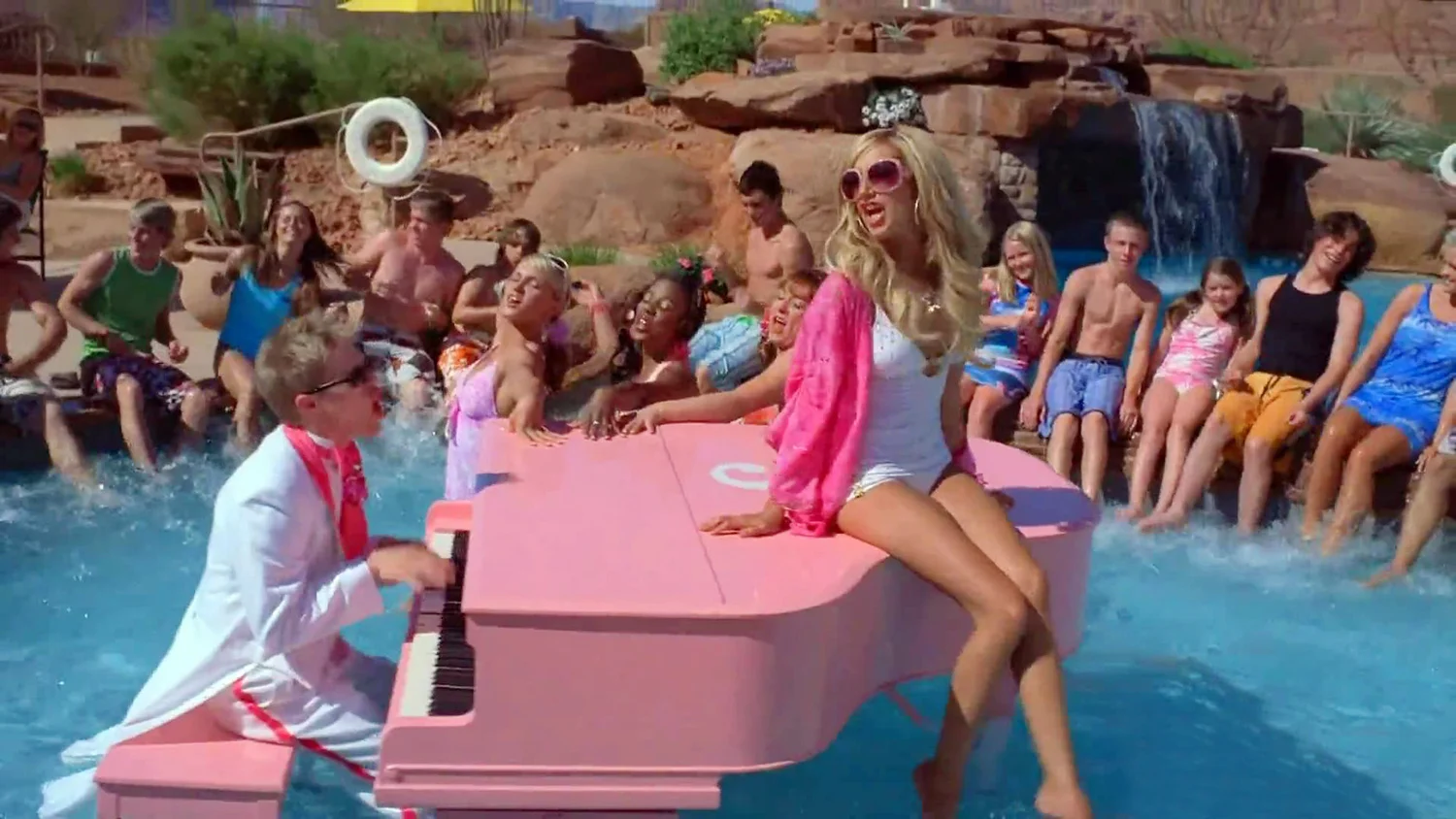 Musical twins Ryan (Lucas Grabeel) and Sharpay (Ashley Tisdale) perform "Fabulous" on the pool's pink grand piano.