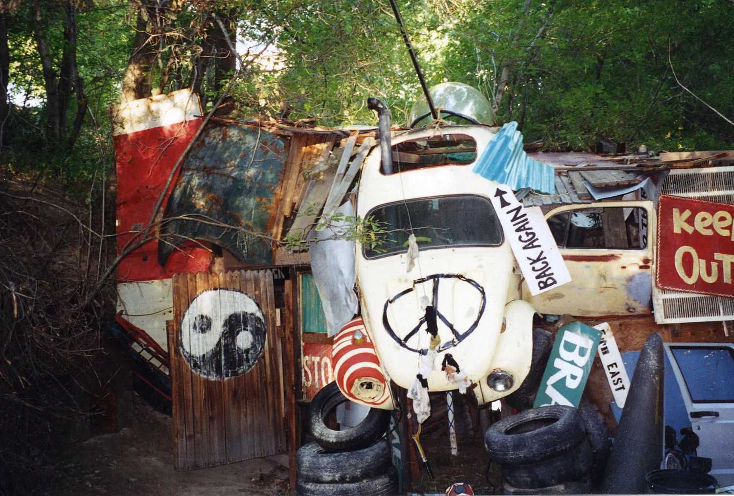 A whimsical forest clubhouse for the local kids, who are supposed to have cobbled it together from whatever garbage they could find. The entrance is the tilting beetle, whose hood opens with a secret lever hidden in the hollow of a tree.