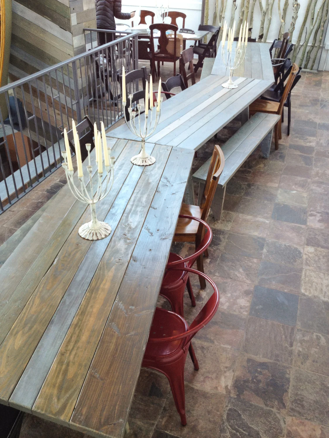 We made enough tables to seat 120 people for a single dinner. I individually stained each plank in our cool wintery palette before they were assembled into tables. We wanted to do beer-garden style common tables, but I felt like we needed to give the idea an update, so I cut the ends of the tables into shallow angles, so when we put them together they made a subtle zig-zag.