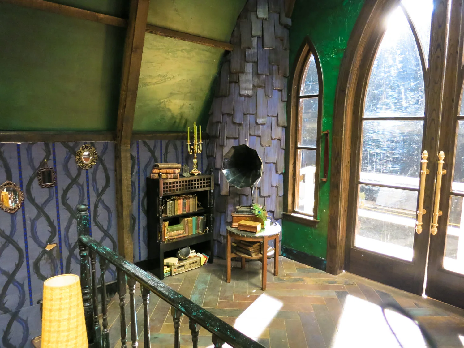 Maleficent's scratchy Victrola. Notice the double helix of the custom wallpaper. It evokes both Maleficent's classic thorn vine's from Sleeping Beauty and the idea of the DNA of evil. Does it pass from one generation to the next, or can one change their destiny?