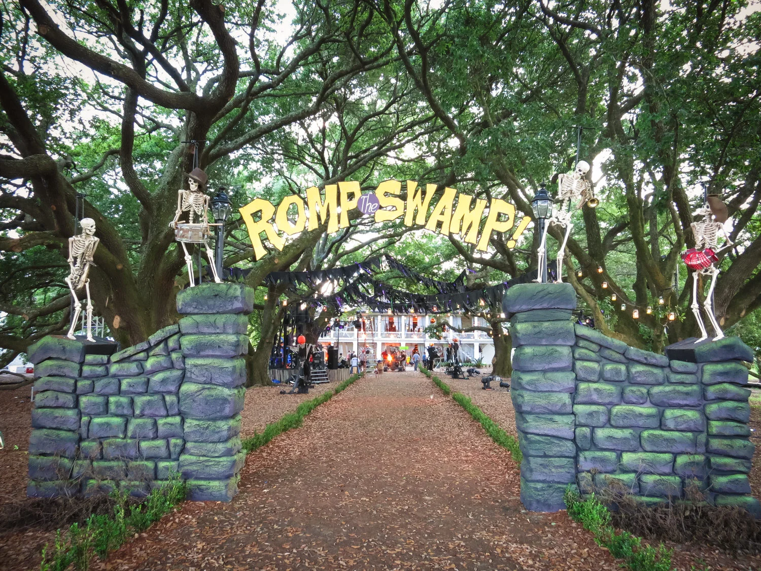 This is the entry gate to the Romp the Swamp Halloween dance. We built this at the far end of the Oak walk at the historic Whitney Plantation. The skeletons were hung by elastic from above so we could give them a little puppeted boogie with the music by pulling on them from below.