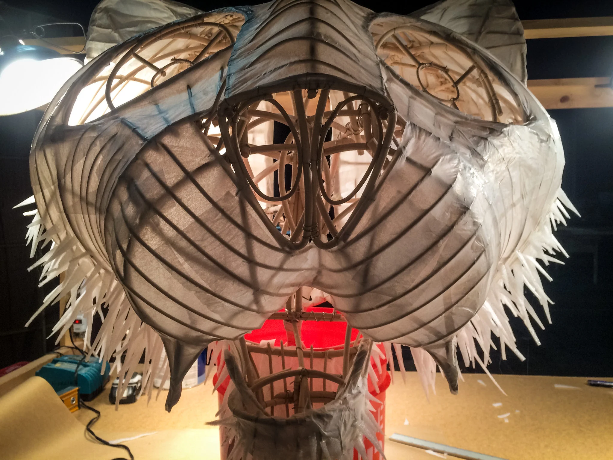 A tissue-paper mache` served as a surprisingly strong skin. The translucent paper let the structure become natural tiger stripes, and picked up the color of any light projected on it.