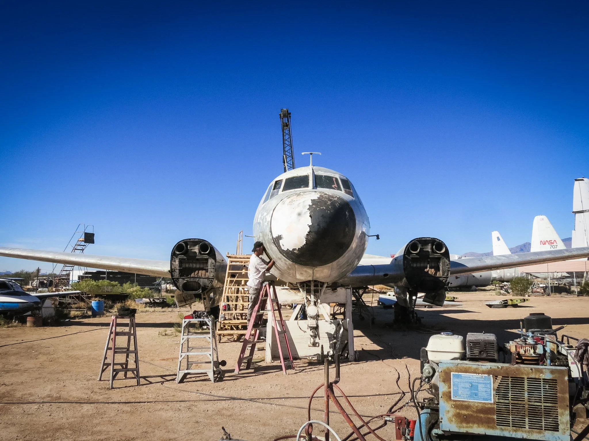 The central focal point of the exhibit needed to be a large aircraft that hung over the gallery space. The design philosophy of the exhibition came down to one word - "permission". Visitors would be allowed to walk on and into this main asset. Matias Alvarez and I went shopping for this prize at the famous boneyards in Tucson. Here is our mothballed C-131 Samaritan being prepared for it's trip north. 