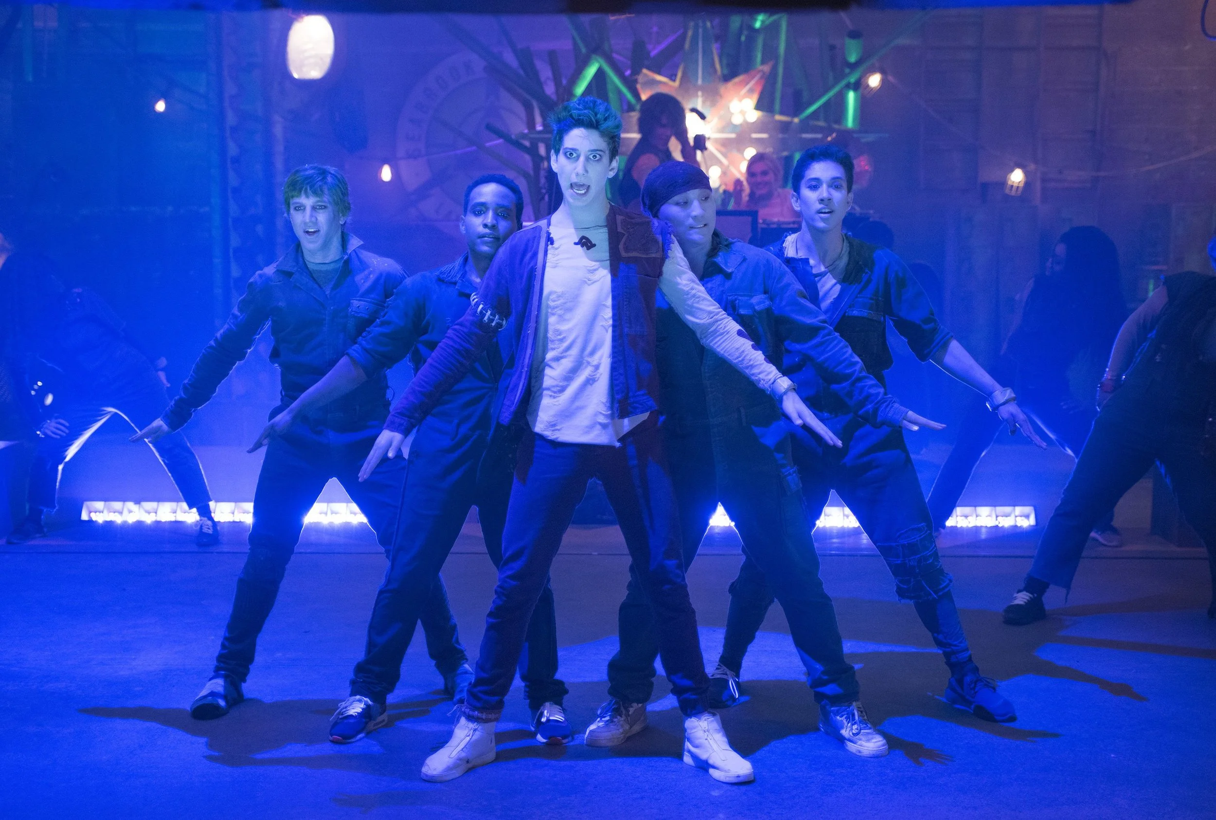 Zed (Milo Manheim) leads the zombie dancers in BAMM in the ruined energy plant.
