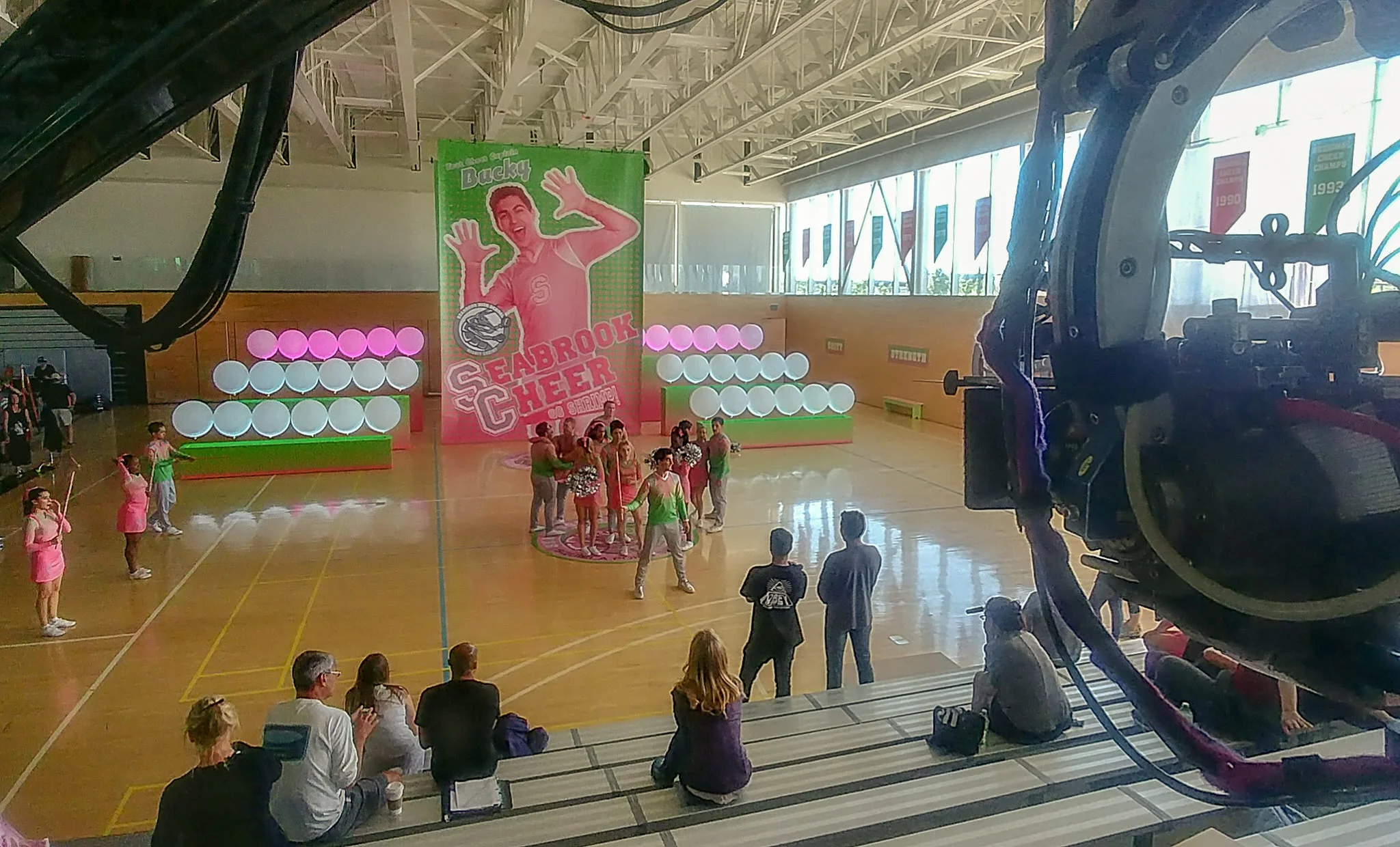 The cult of cheer captain Bucky (Trevor Tordjman) is expressed in near religious terms at Seabrook high. The pep rally is an expression of that cult of personality. LED color bars illuminate the perfectly spaced, 36" balloons that frame his layered graphics.