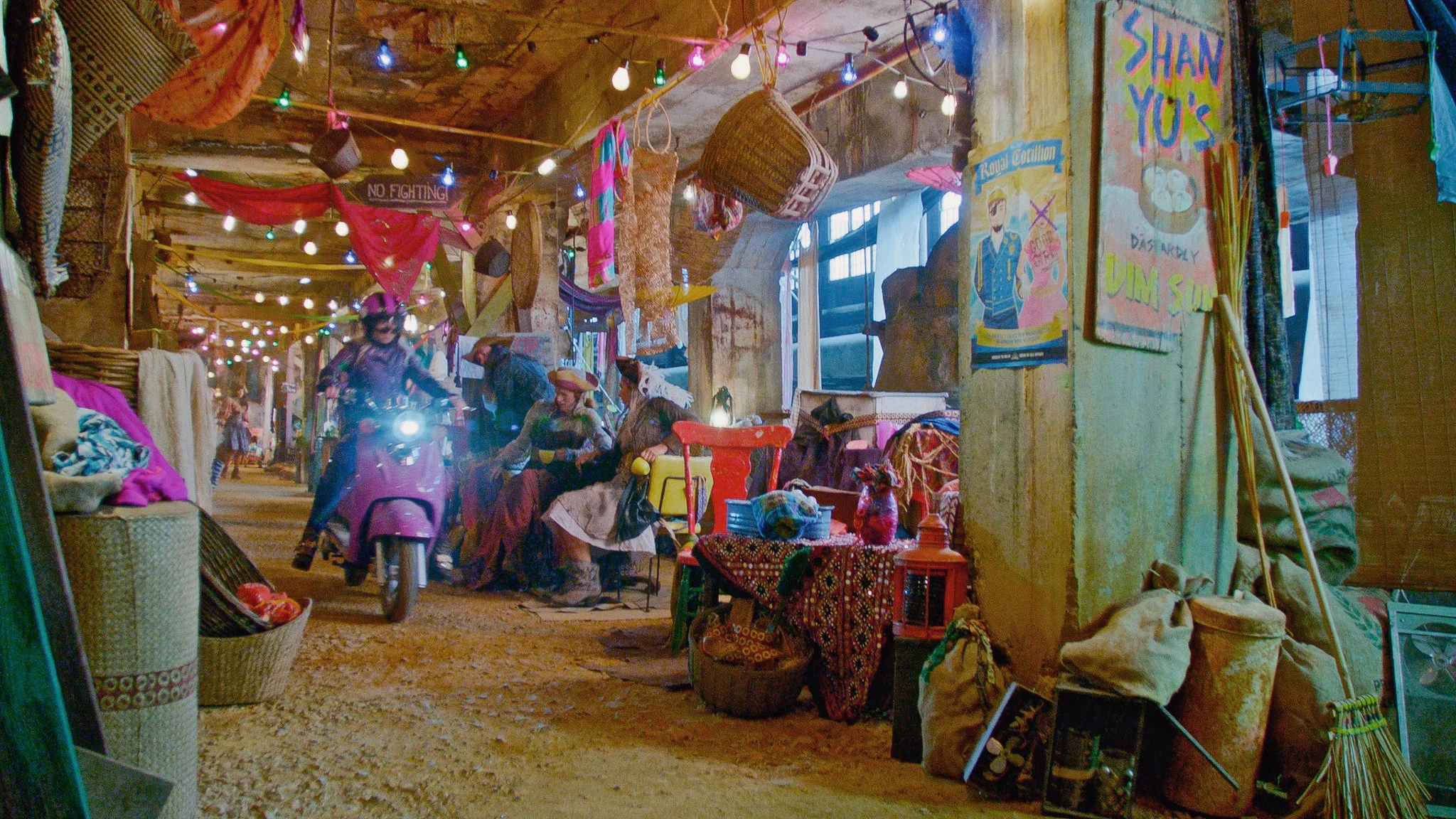 Mal (Dove Cameron) speeds through the Bazaar on her enchanted scooter on the Isle of the Lost.