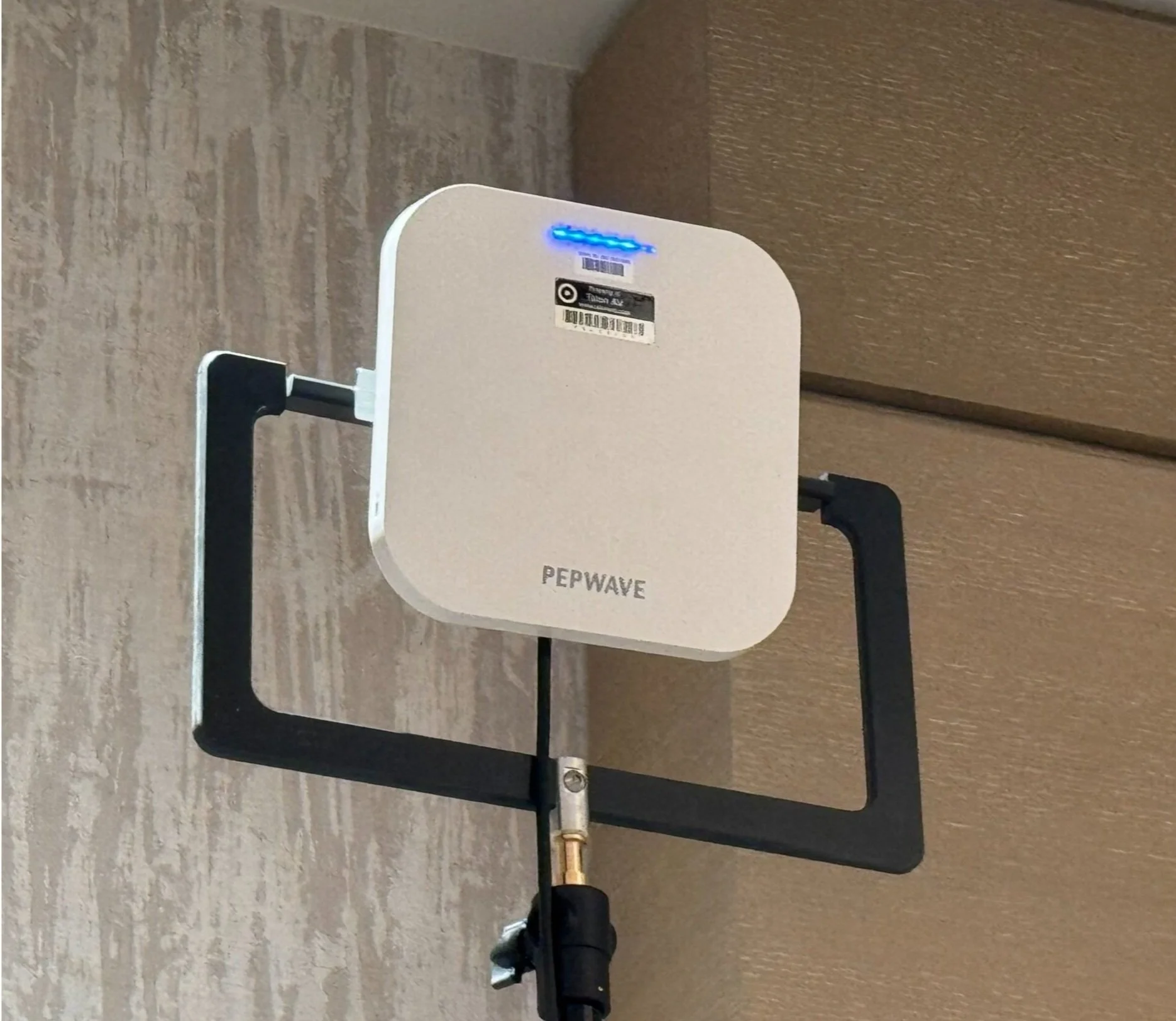 A Wireless Access Point is mounted on a stand in a hotel ballroom