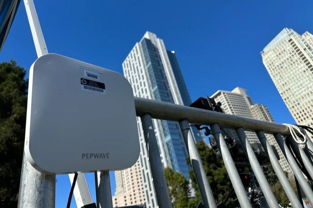 A wireless access point is hung from a railing in a park in San Fransisco