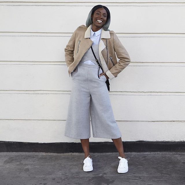Shearling moto jacket, white button-down and dove grey jumpsuit look impeccable. And her hair is super cool. Via Refinery29 .