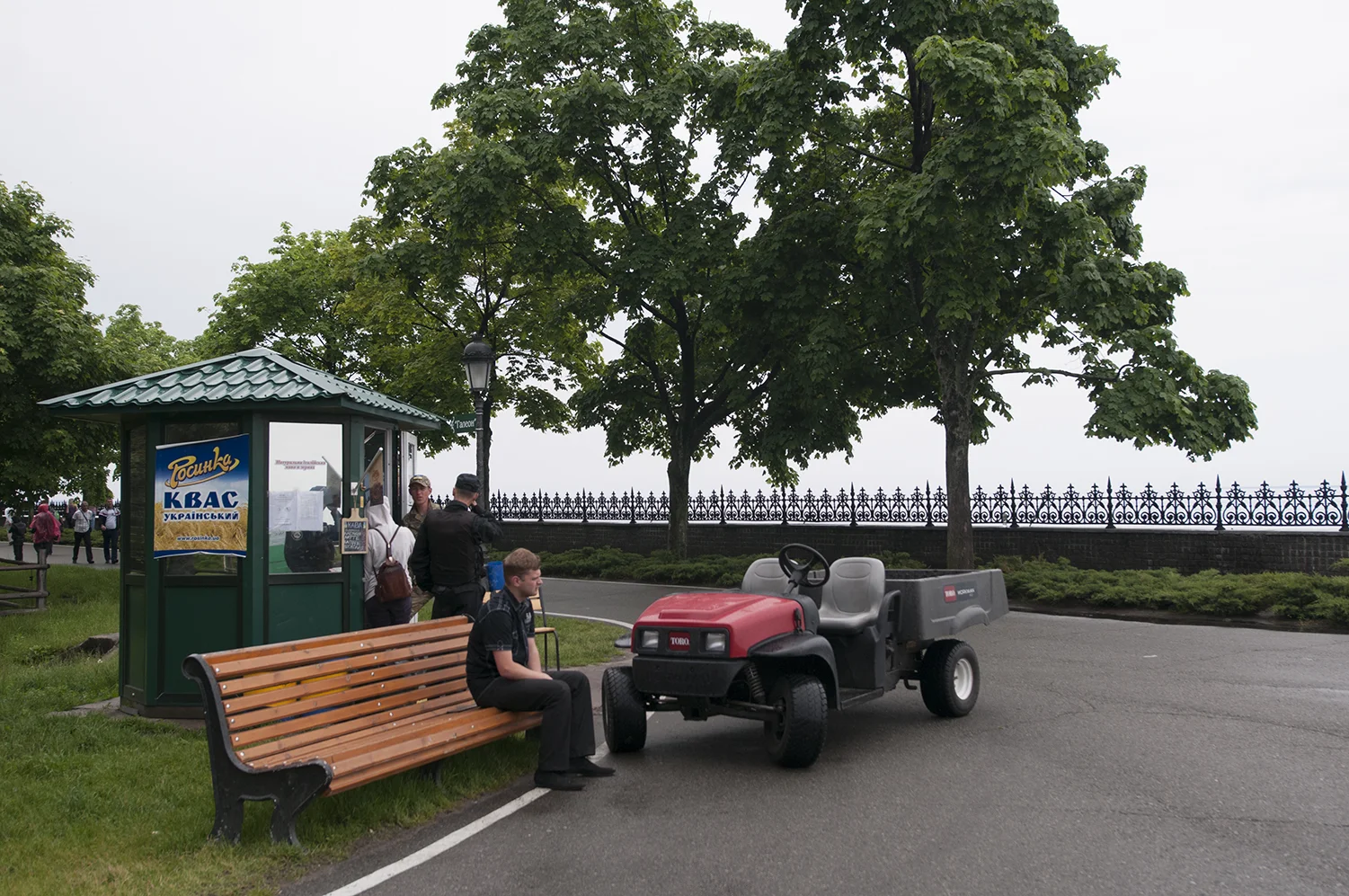 Two guards with civilians at an icecream booth