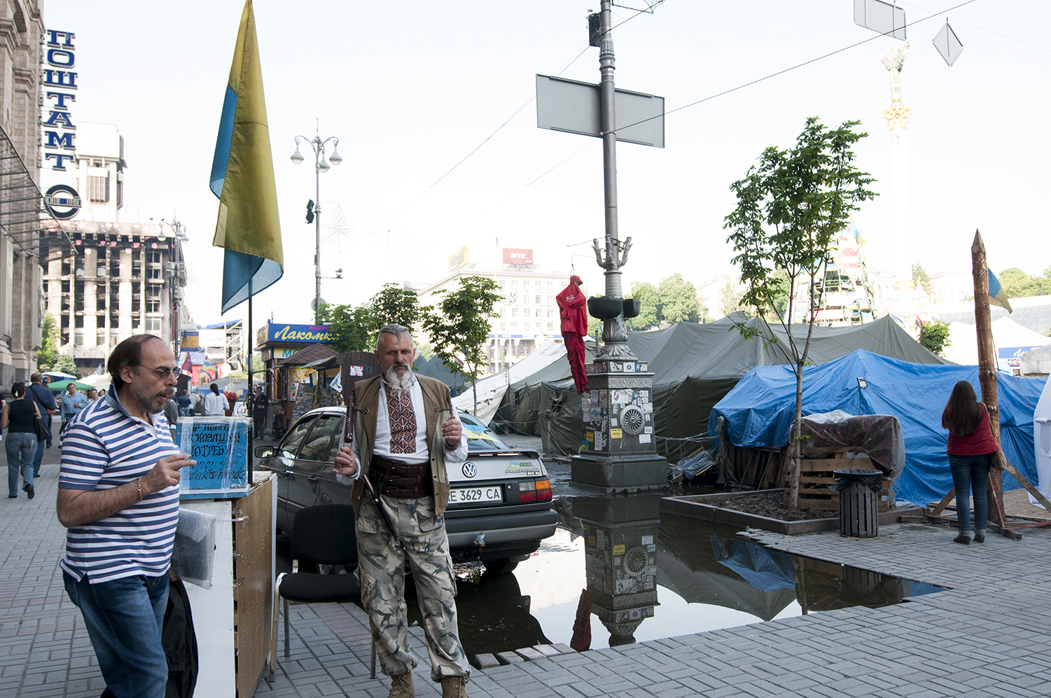 Cossack standing next to on of the numerous donation boxes present on Maidan 