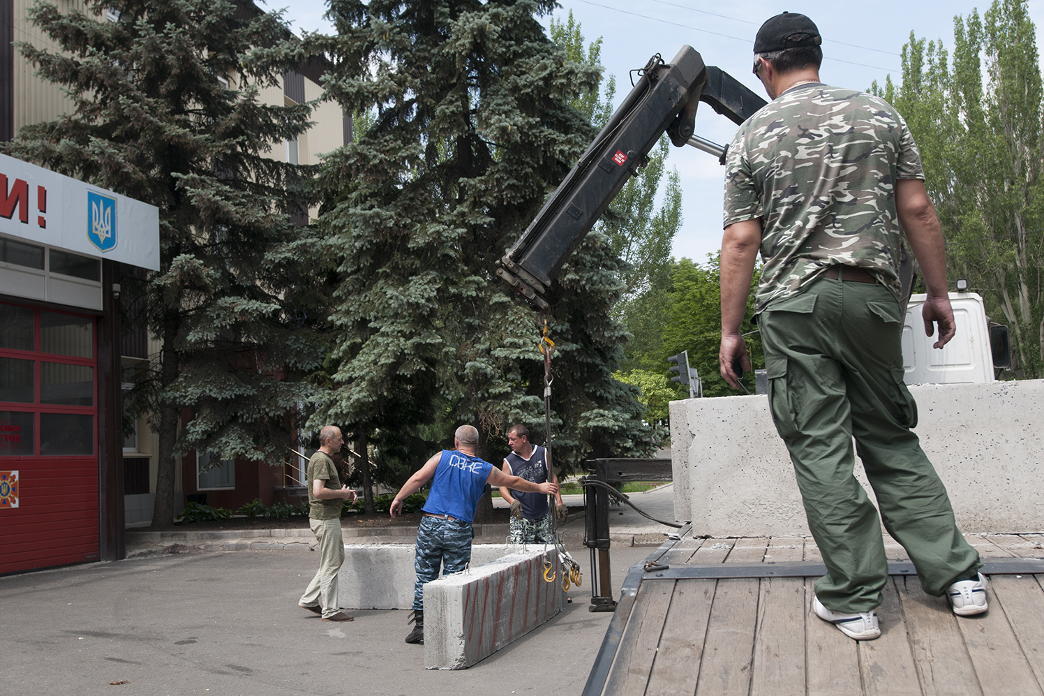Men putting concrete block to restrict the access to the fire station near the SBU Building 