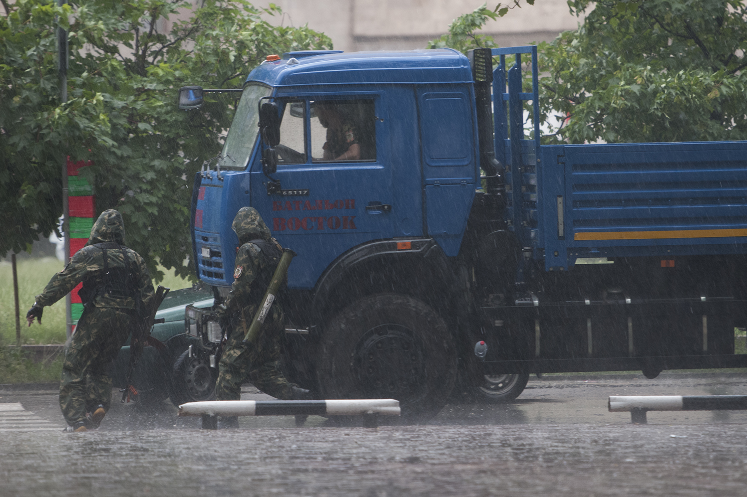 Soldiers from the Vostok Battalion running to cover as a thunderstorm begins 