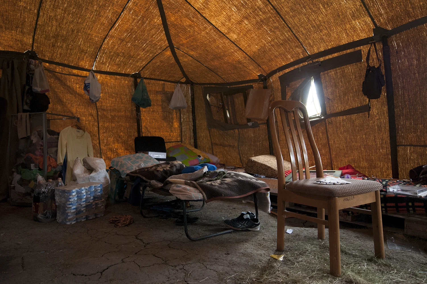 Stolen goods near the sleeping bed of the tent located in front of the ODA